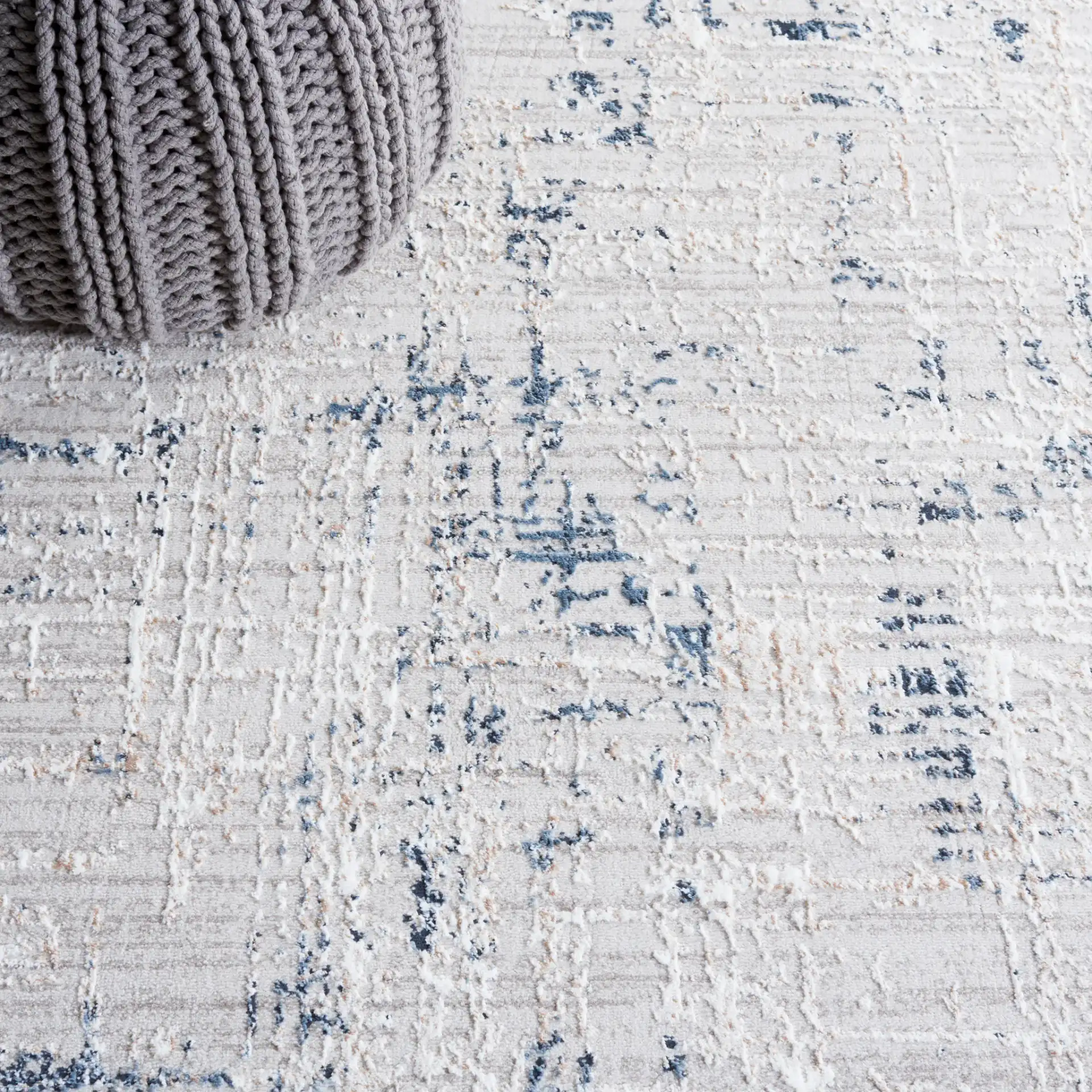 Parker Distressed Grid Rug in Taupe / Gray Blue in a styled room