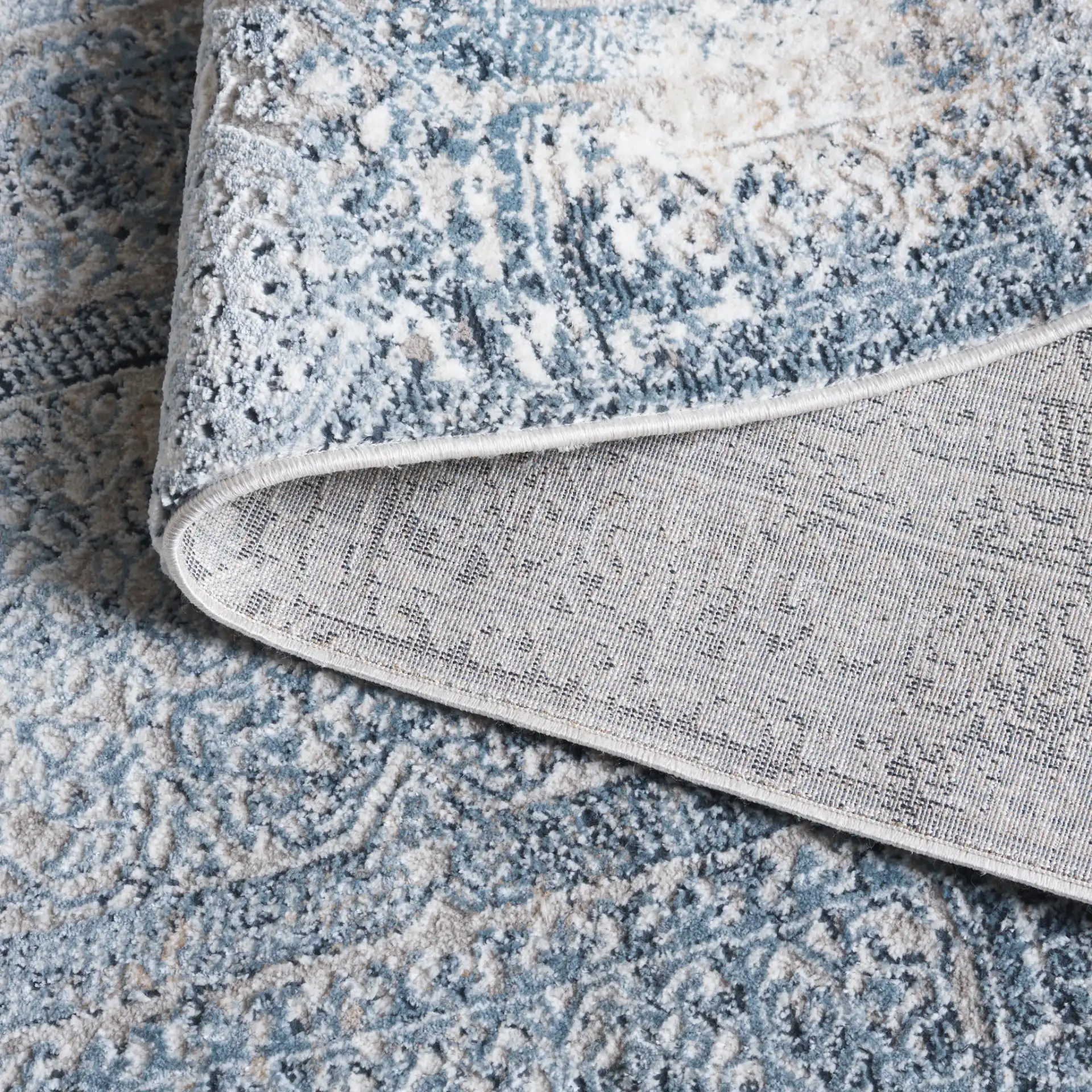 Parker Distressed Panel Rug in Blue / Taupe in a styled room