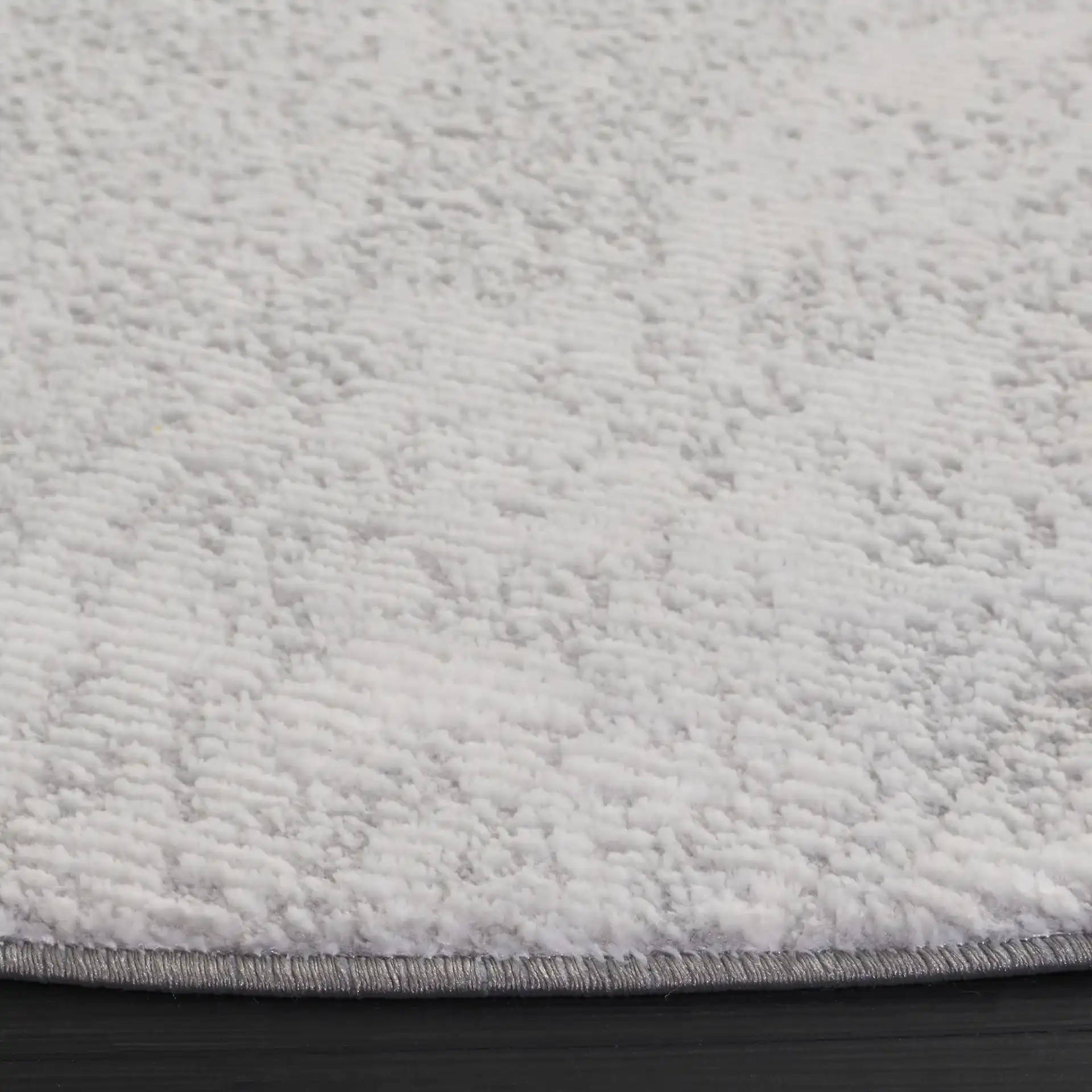 Parker Textured Solid Rug in Gray / Light Gray in a styled room