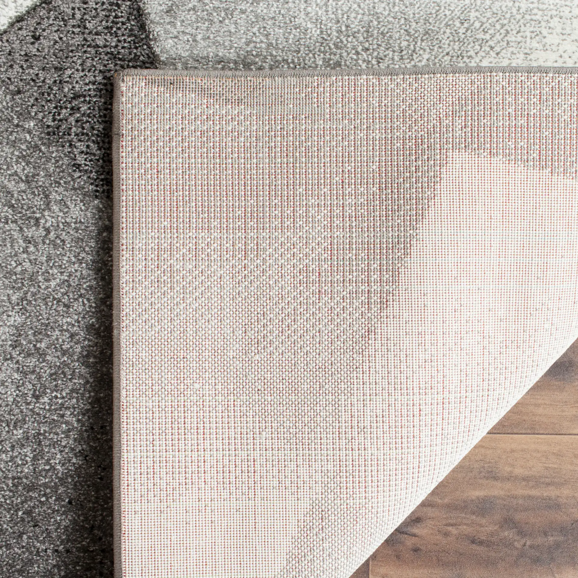 Porcello Faceted Geometric Rug in Light Gray / Charcoal in a styled room