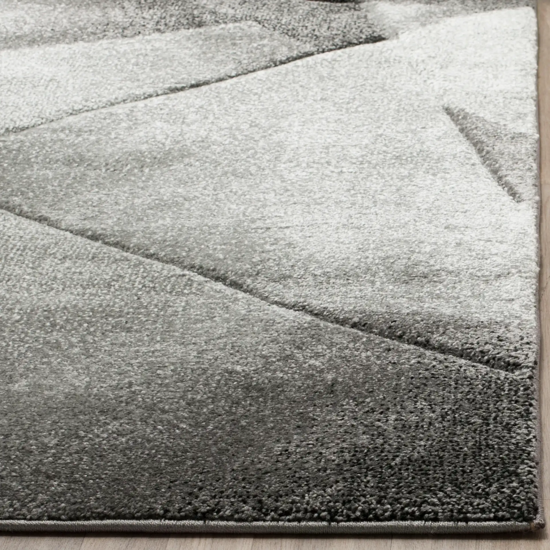 Porcello Faceted Geometric Rug in Light Gray / Charcoal in a styled room