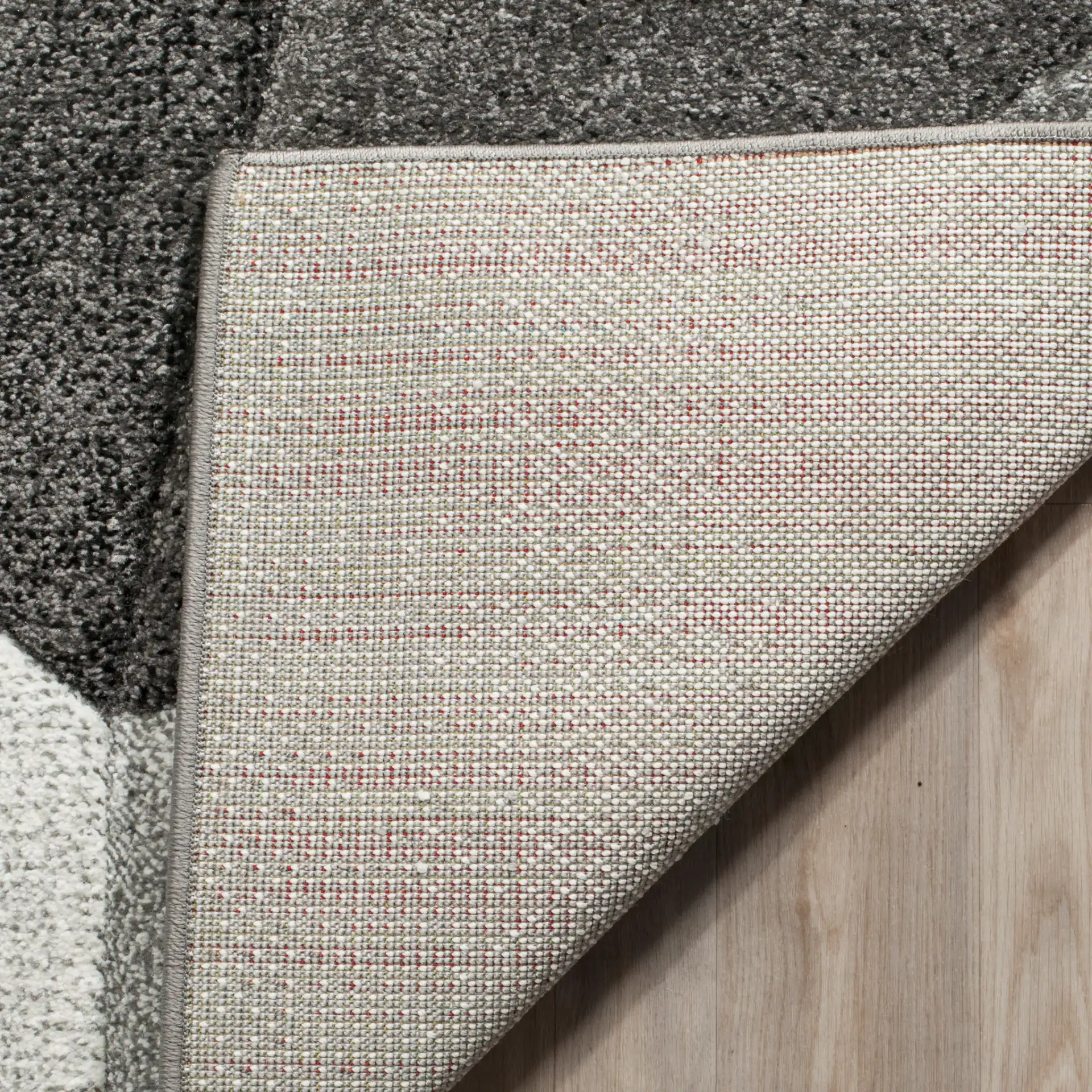Porcello Faceted Geometric Rug in Light Gray / Charcoal in a styled room