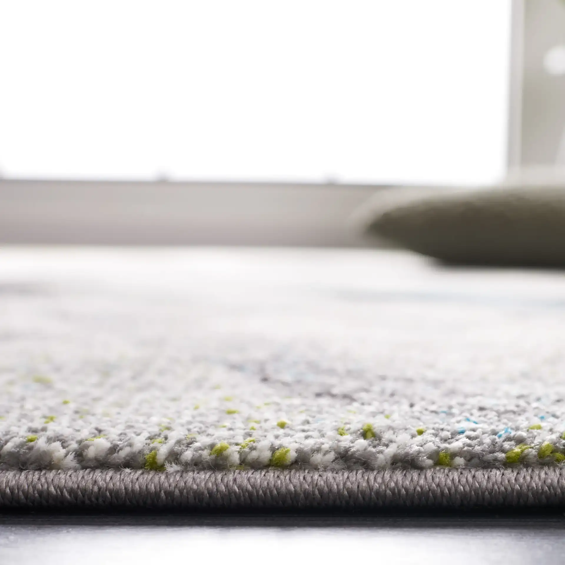 Porcello Overlapping Triangles Rug in Gray / Blue in a styled room