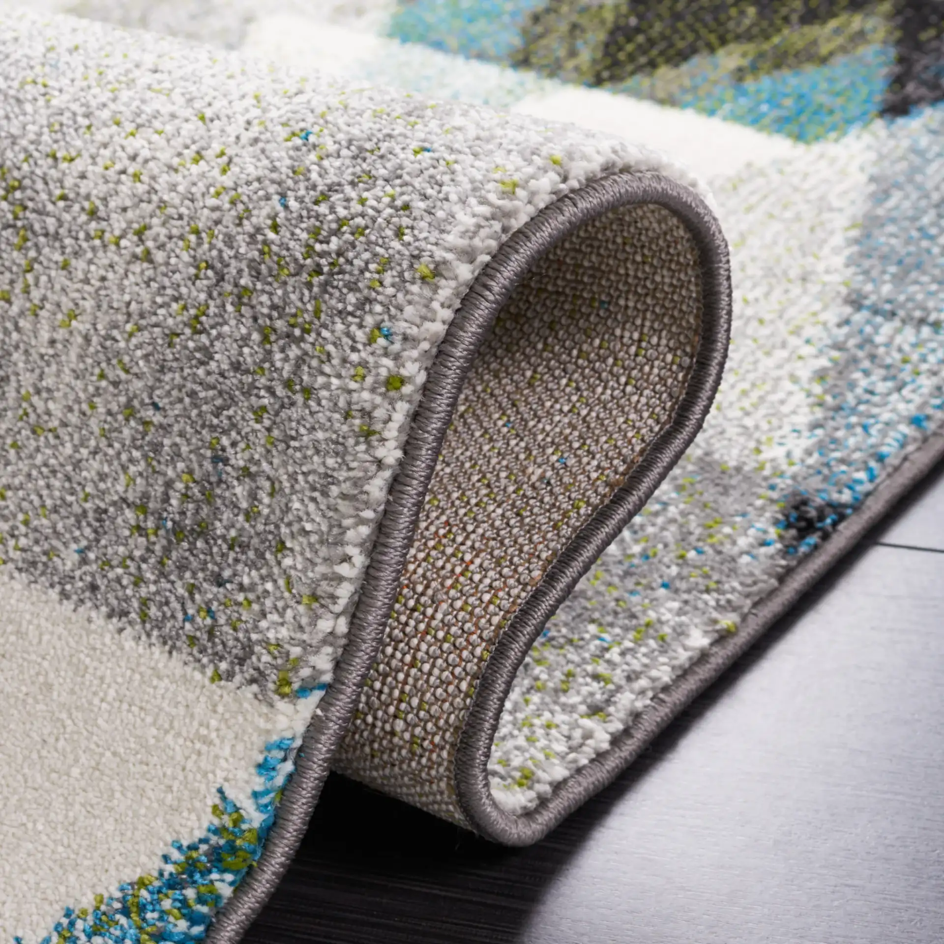 Porcello Overlapping Triangles Rug in Gray / Blue in a styled room