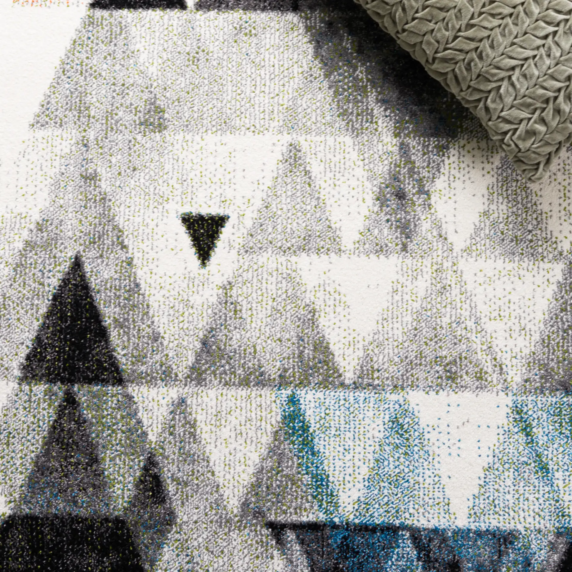 Porcello Overlapping Triangles Rug in Gray / Blue in a styled room