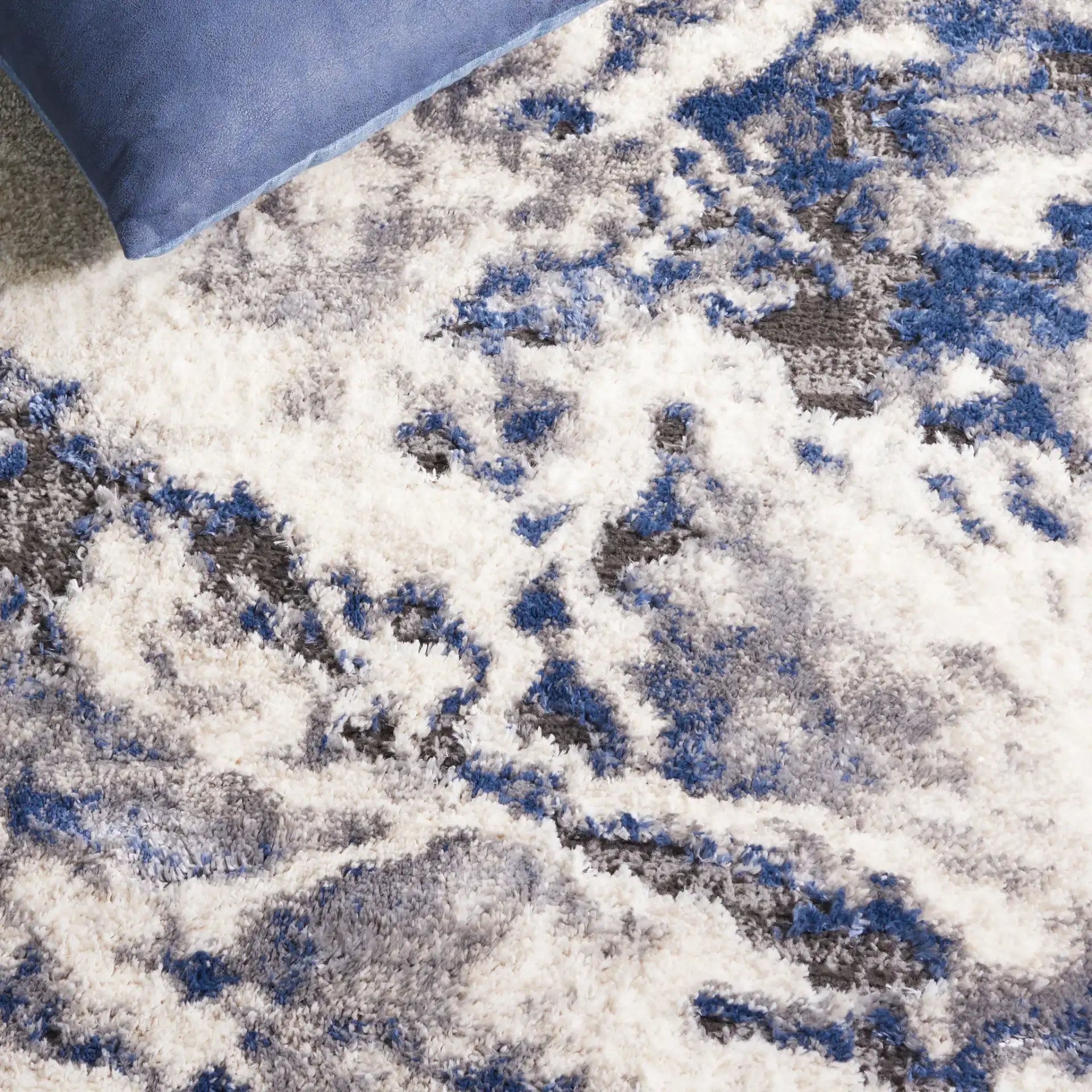 Petra Marbled Rug in Ivory / Blue in a styled room