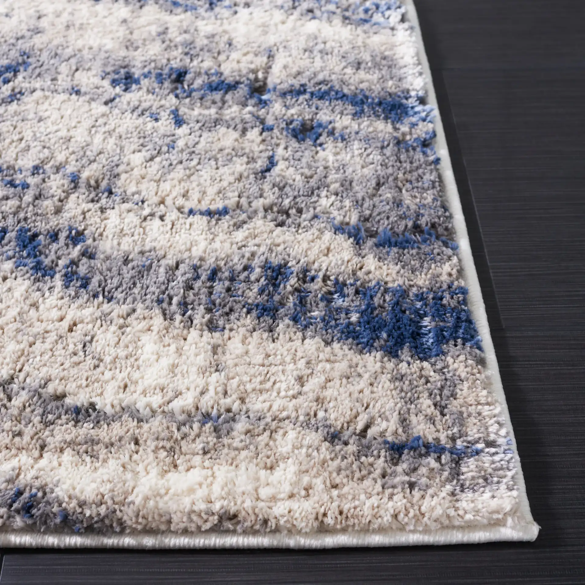 Petra Marble Wave Rug in Light Beige / Blue in a styled room