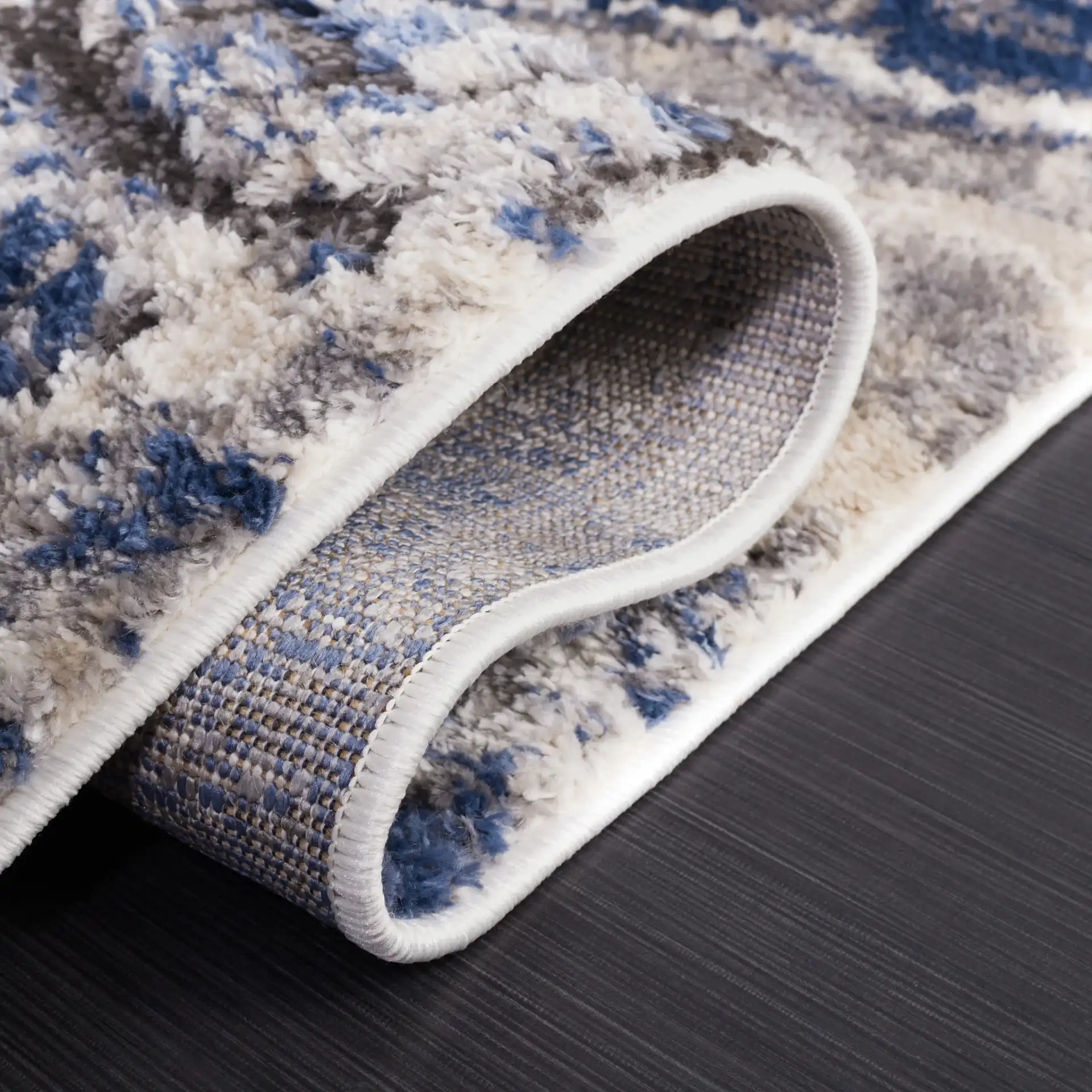 Petra Marble Wave Rug in Light Beige / Blue in a styled room