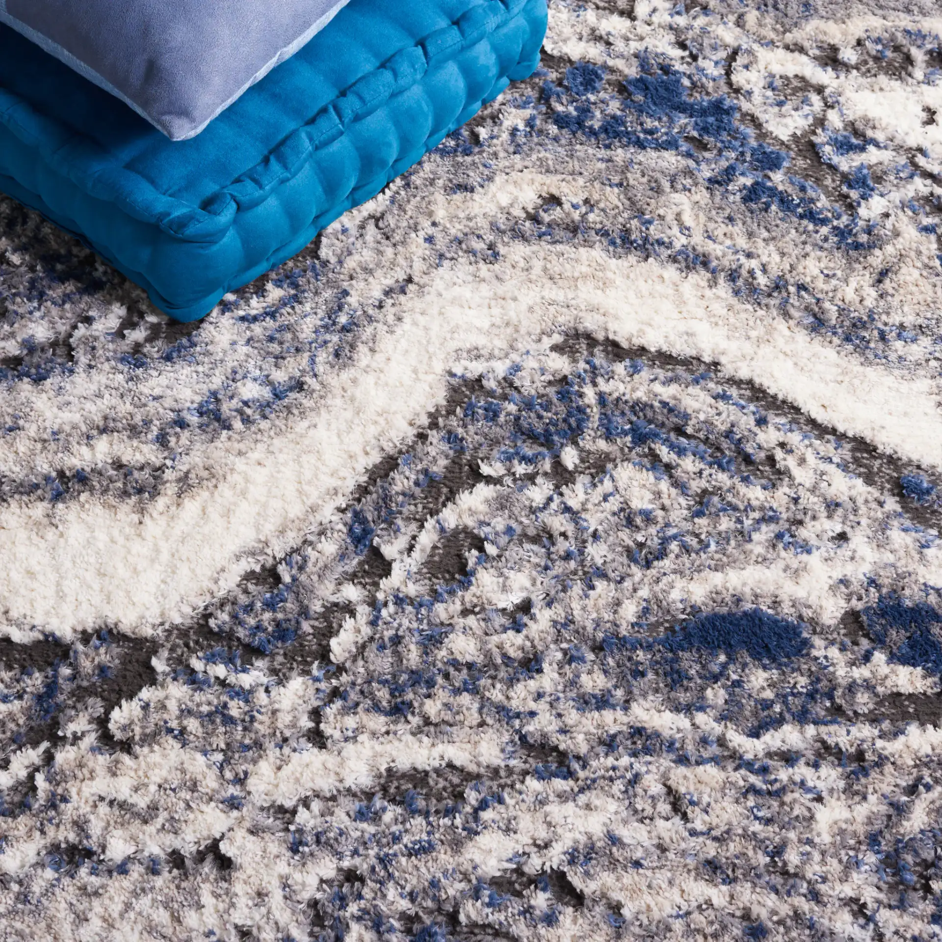 Petra Marble Wave Rug in Light Beige / Blue in a styled room
