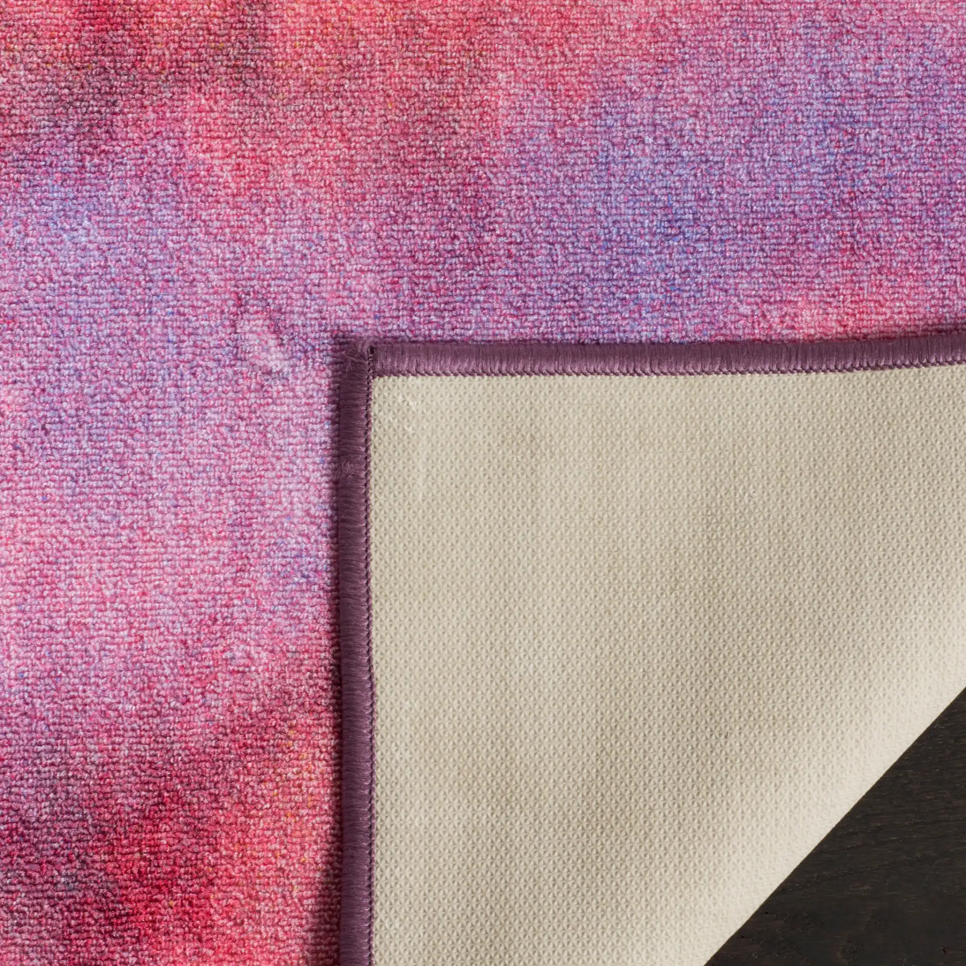 Paint Brush Abstract Washable Rug in Fuchsia / Lavender in a styled room