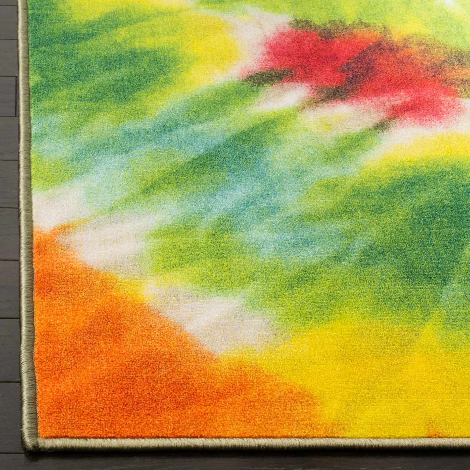 Paint Brush Tie-Dye Swirl Washable Rug in Green / Orange in a styled room