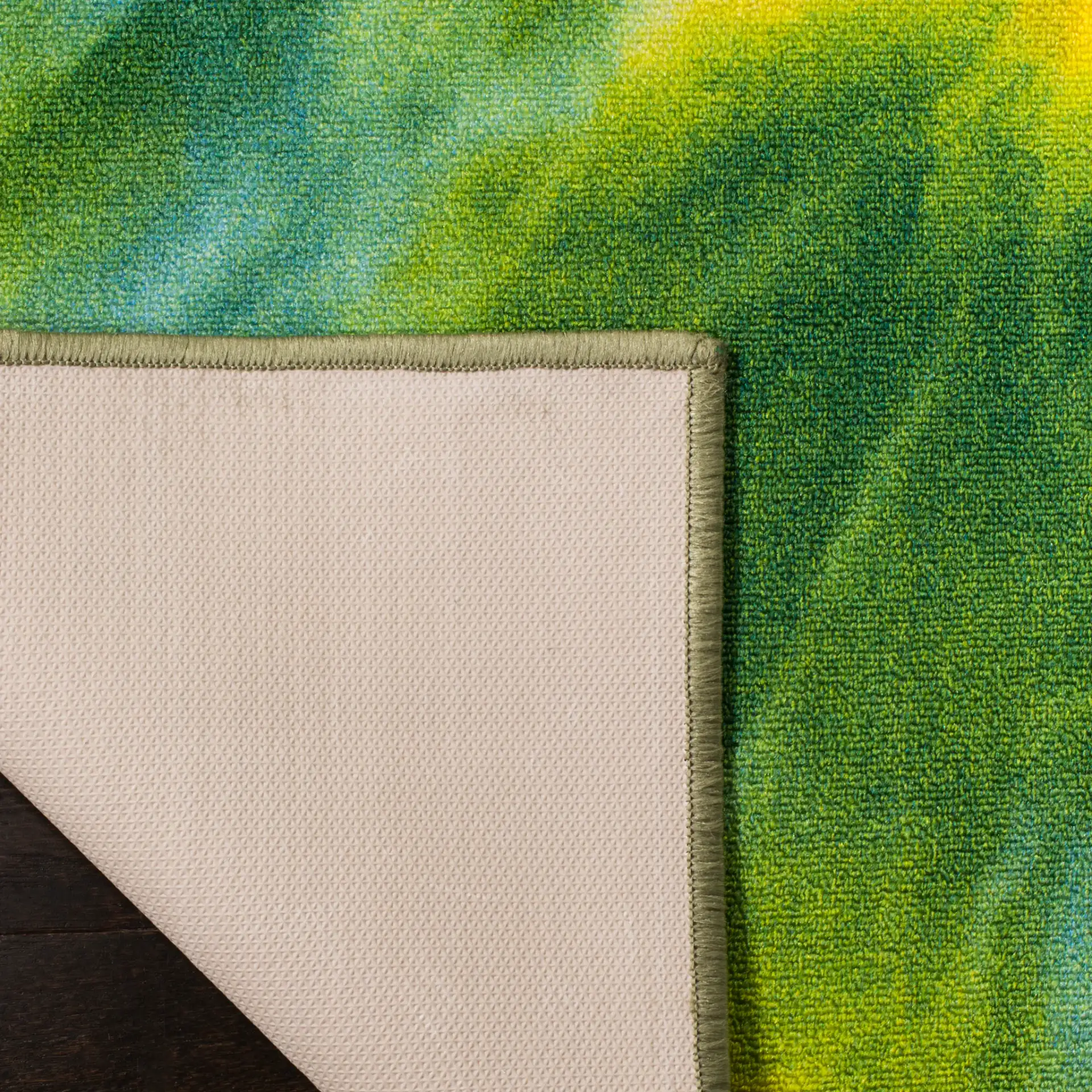 Paint Brush Tie-Dye Swirl Washable Rug in Green / Orange in a styled room