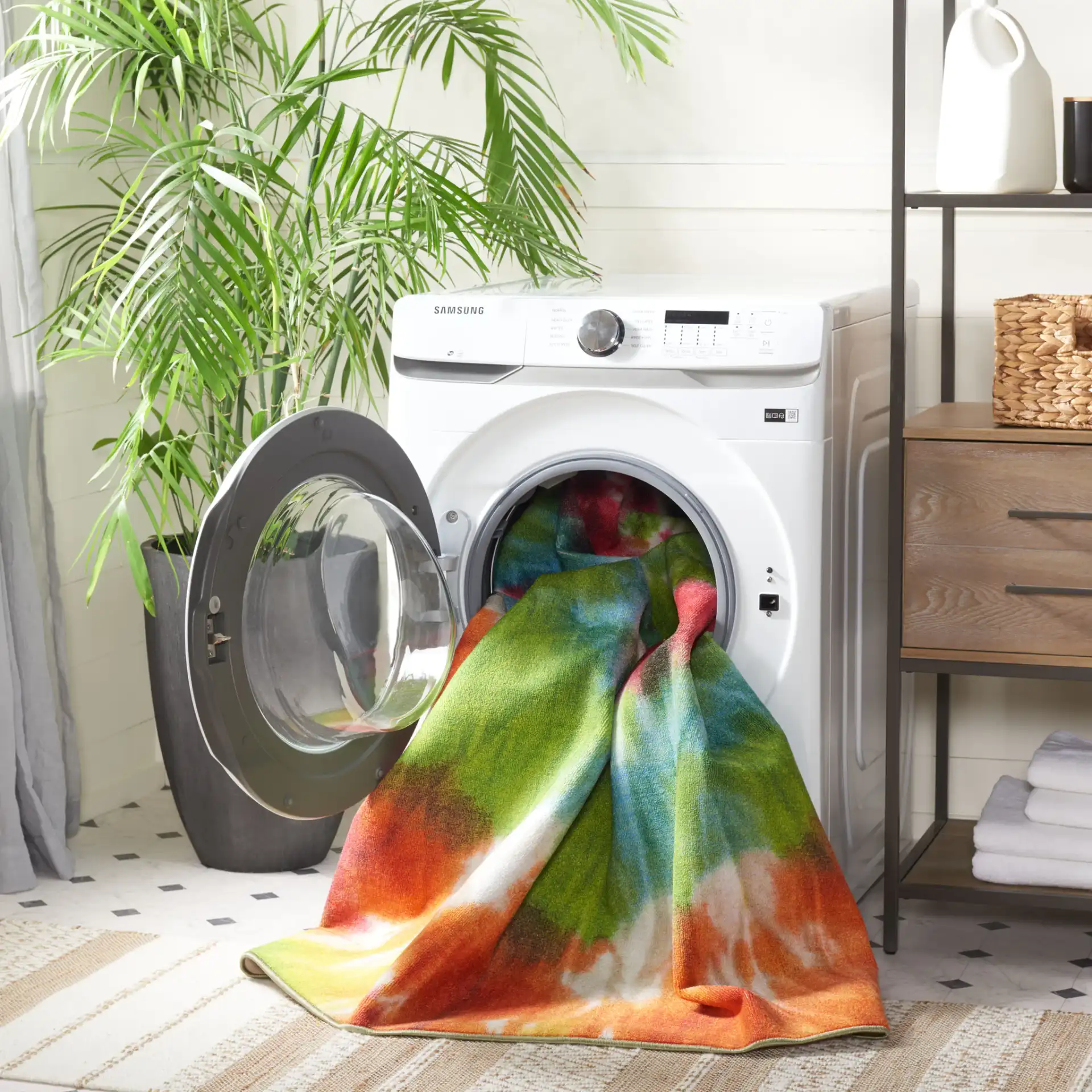 Paint Brush Tie-Dye Swirl Washable Rug in Green / Orange in a styled room
