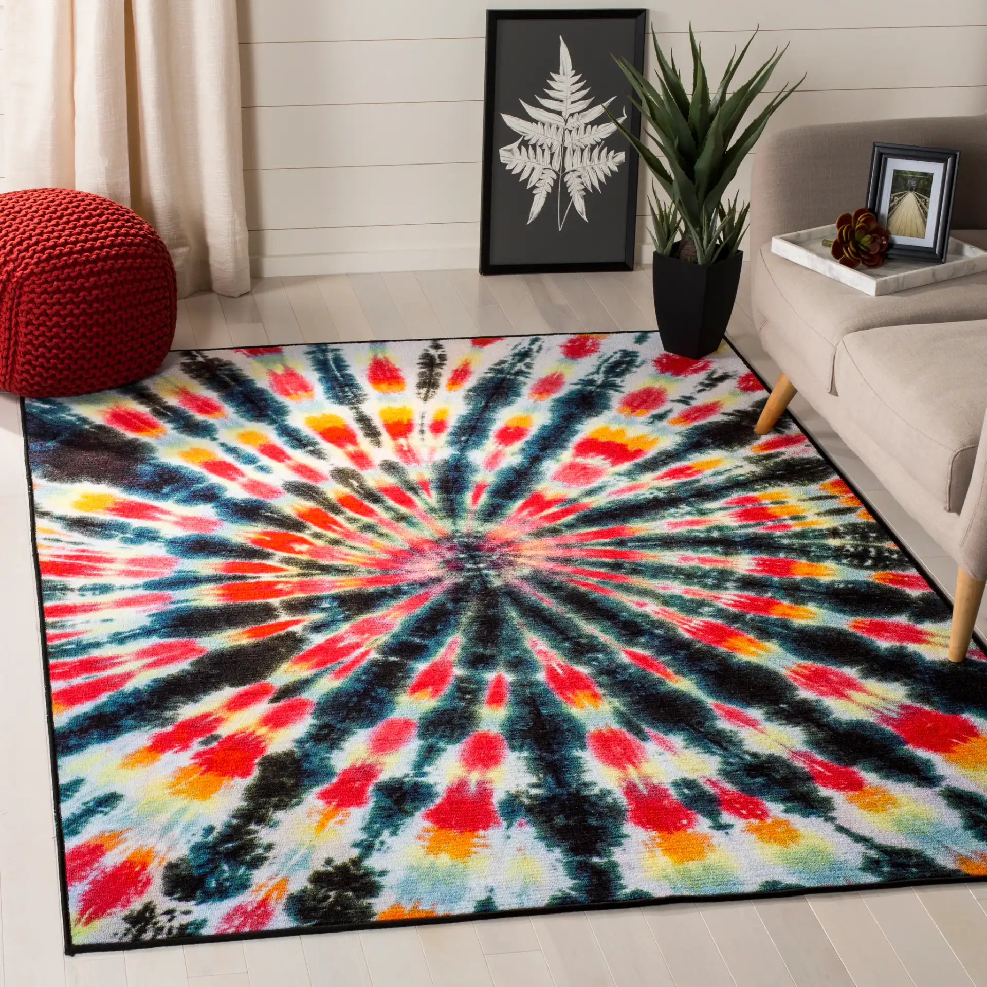 Paint Brush Tie-Dye Spiral Washable Rug in Black / Coral in a styled room