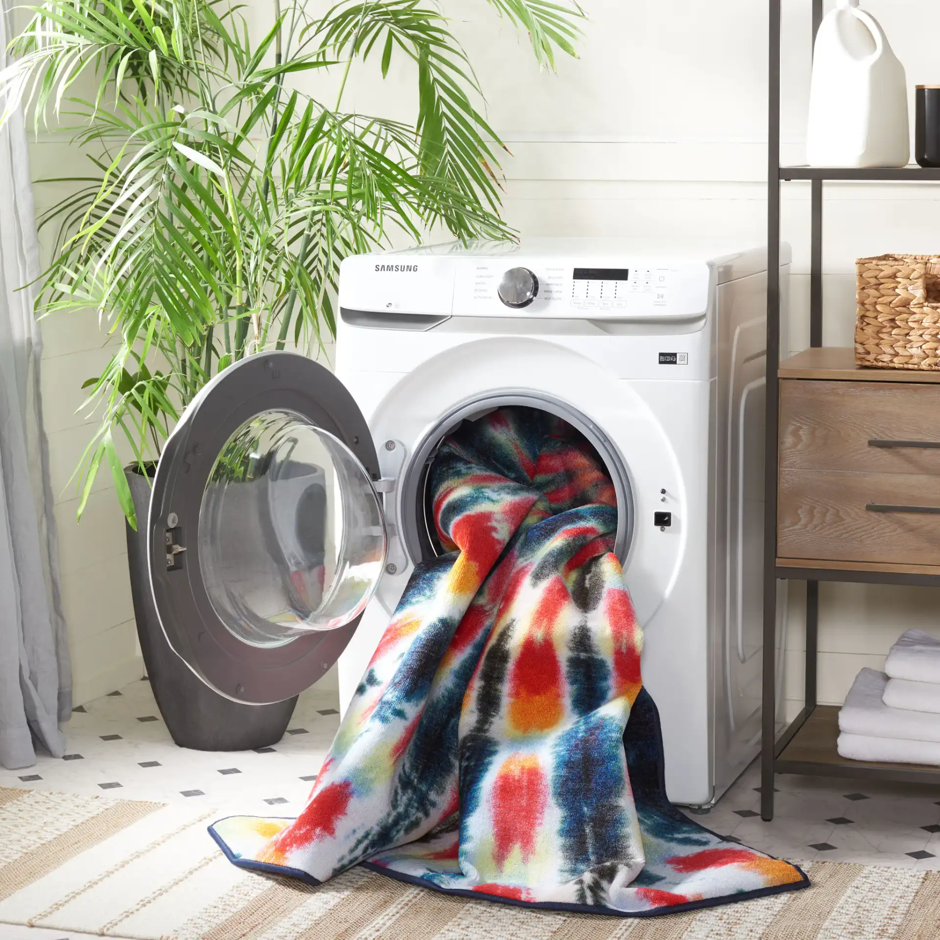 Paint Brush Tie-Dye Spiral Washable Rug in Black / Coral in a styled room