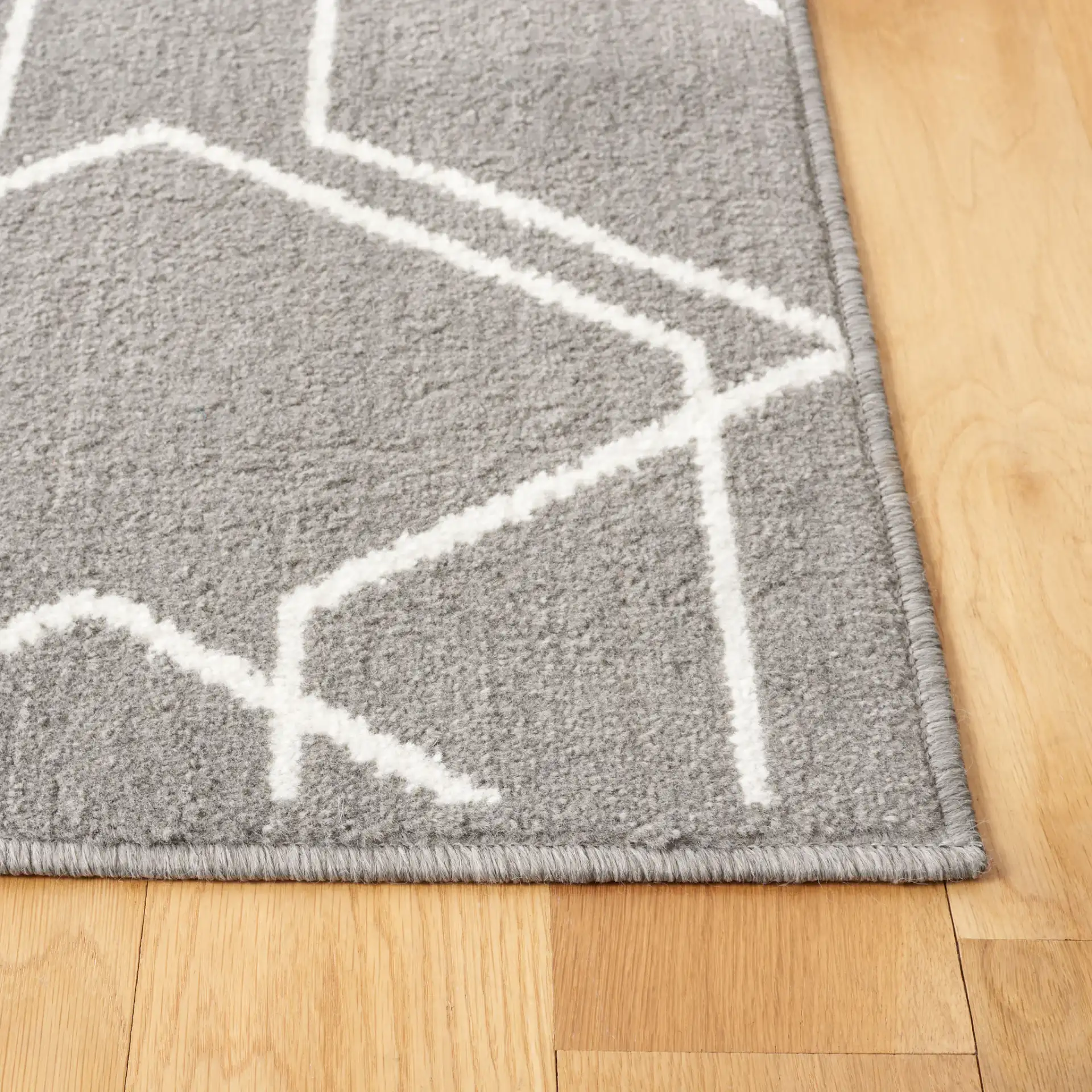 Pyramid Interlocking Cube Rug in Gray / Ivory in a styled room