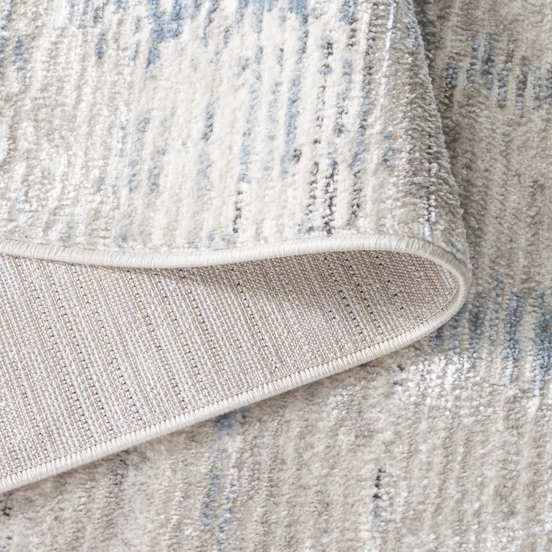 Quincy Faded Column Rug in Ivory / Light Gray in a styled room