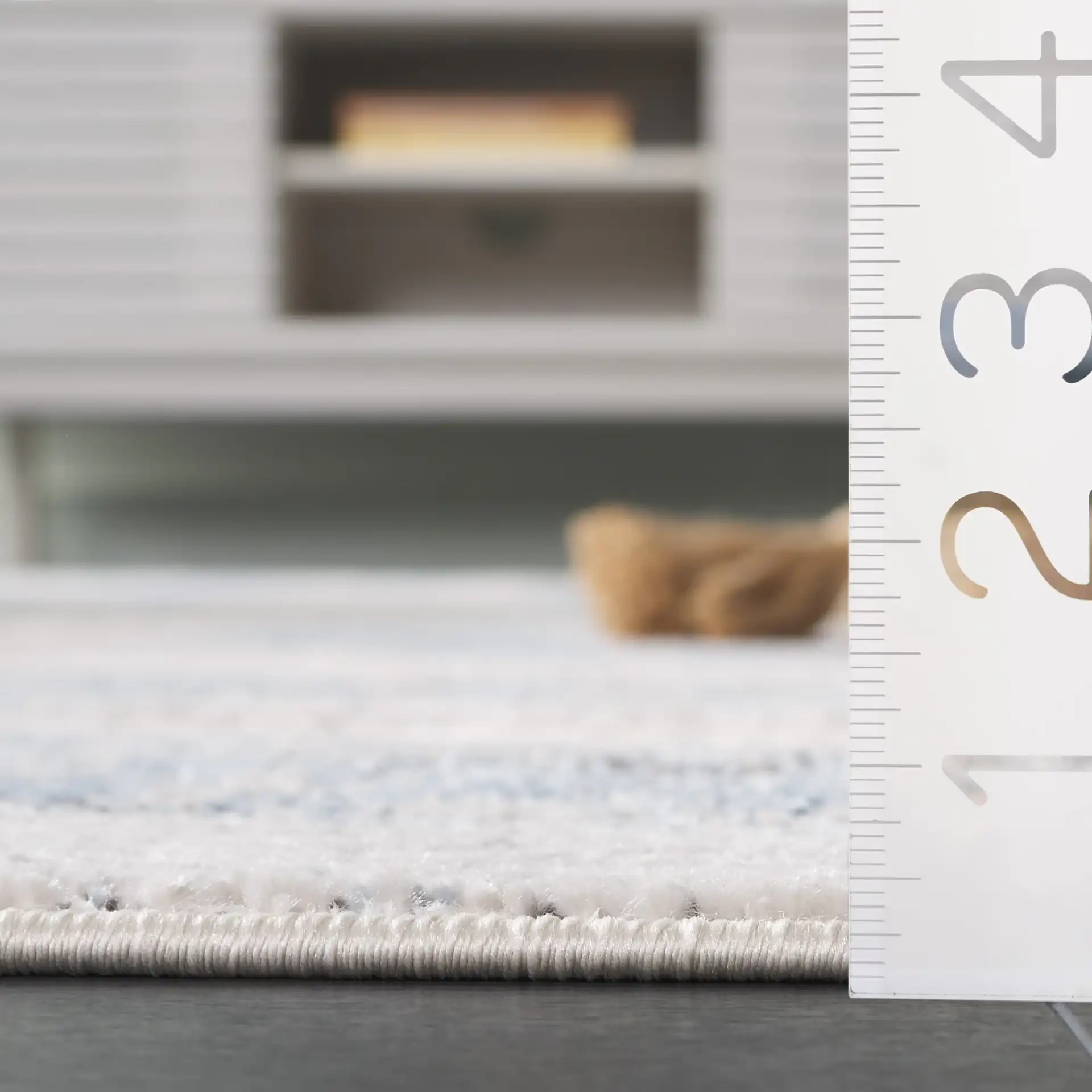 Quincy Abstract Rug in Ivory / Blue in a styled room