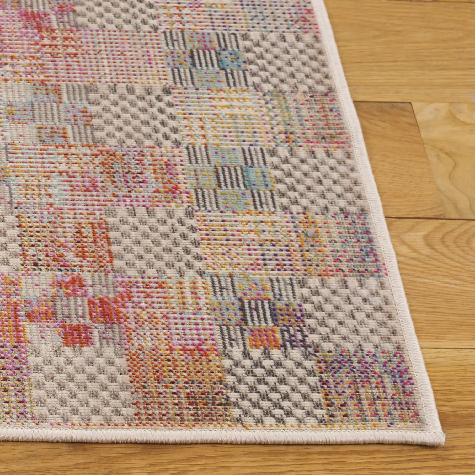 Rainbow Patchwork Grid Outdoor Rug in Blue / Gold in a styled room