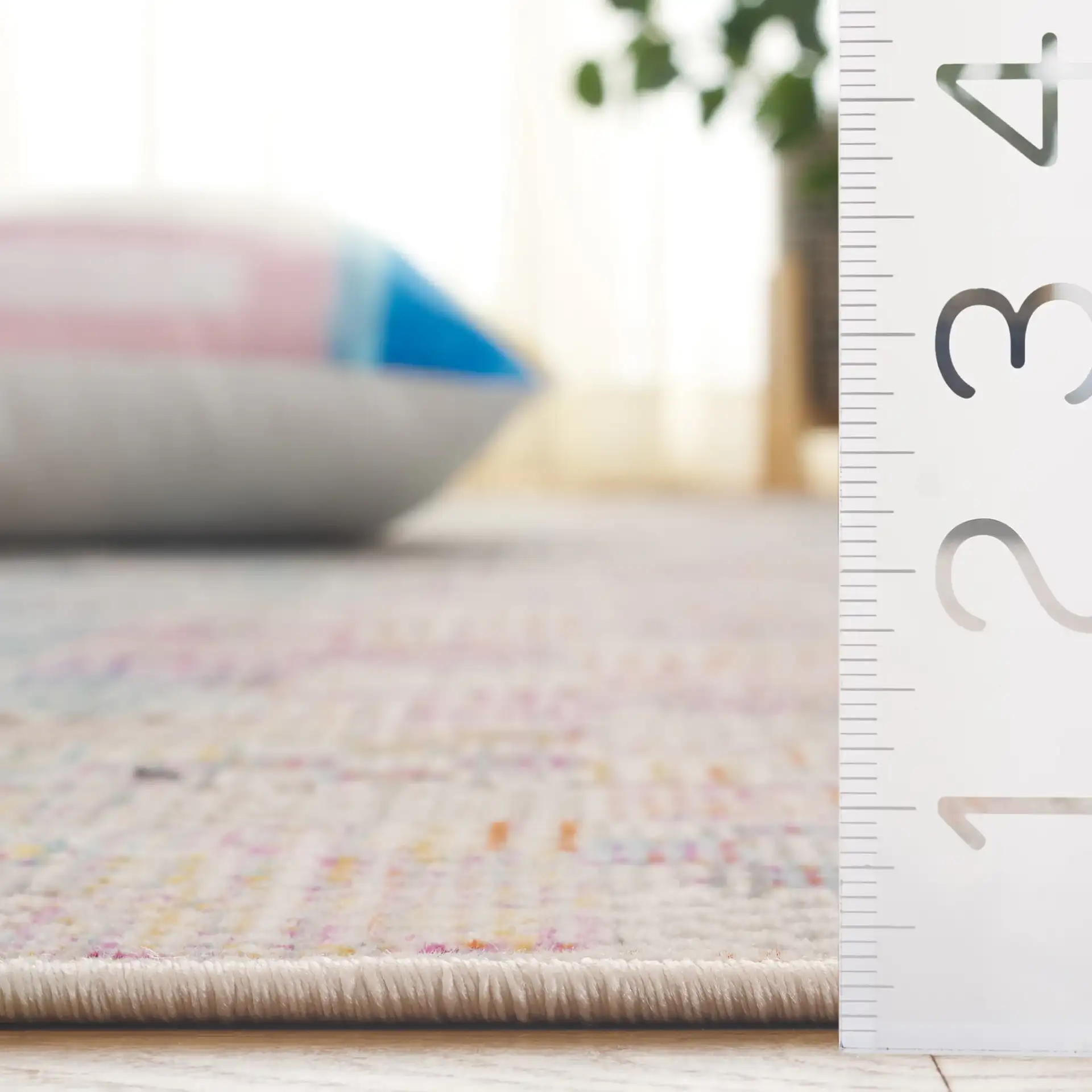 Rainbow Patchwork Grid Outdoor Rug in Blue / Gold in a styled room