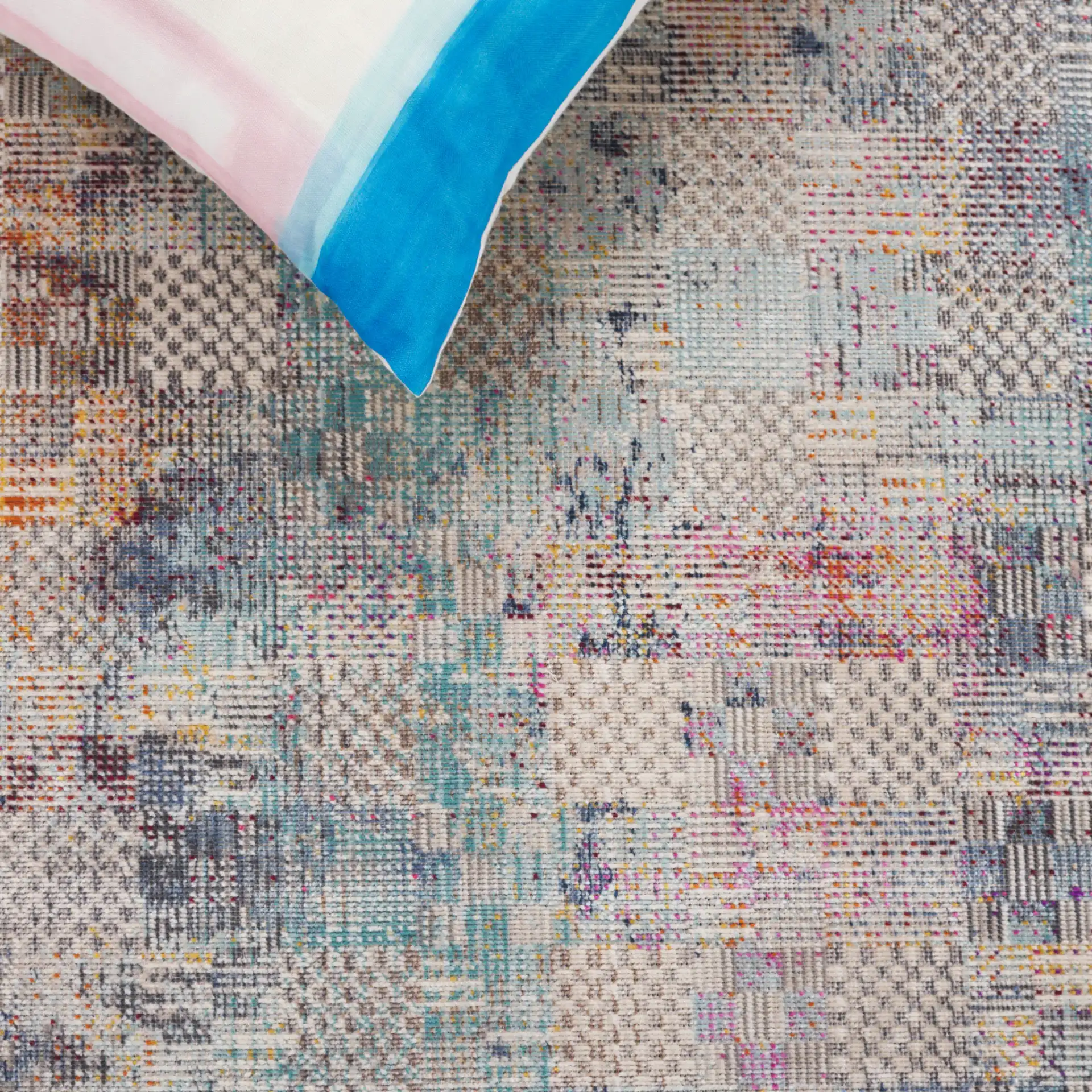 Rainbow Patchwork Grid Outdoor Rug in Blue / Gold in a styled room
