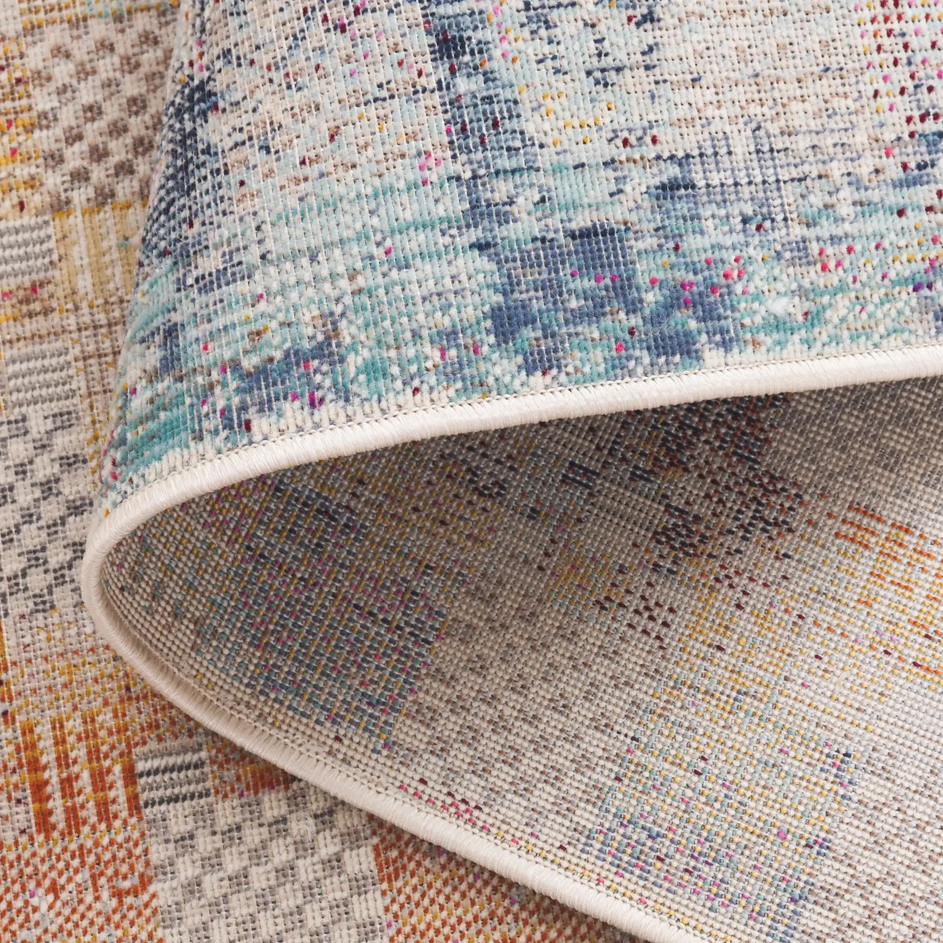 Rainbow Patchwork Grid Outdoor Rug in Blue / Gold in a styled room