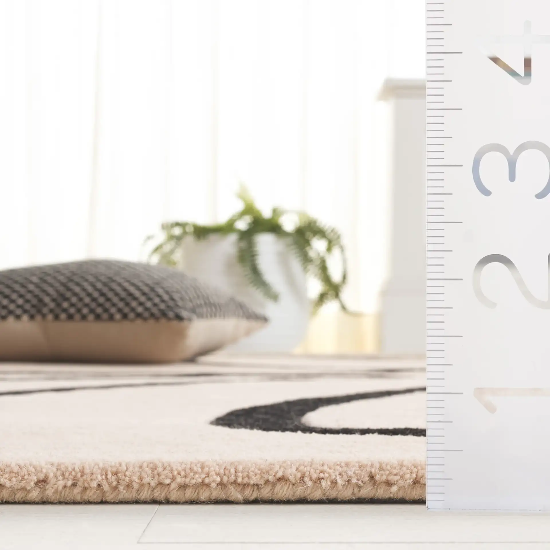 Rodeo Drive Abstract Loop Hand-Tufted Wool Rug in Ivory / Black in a styled room