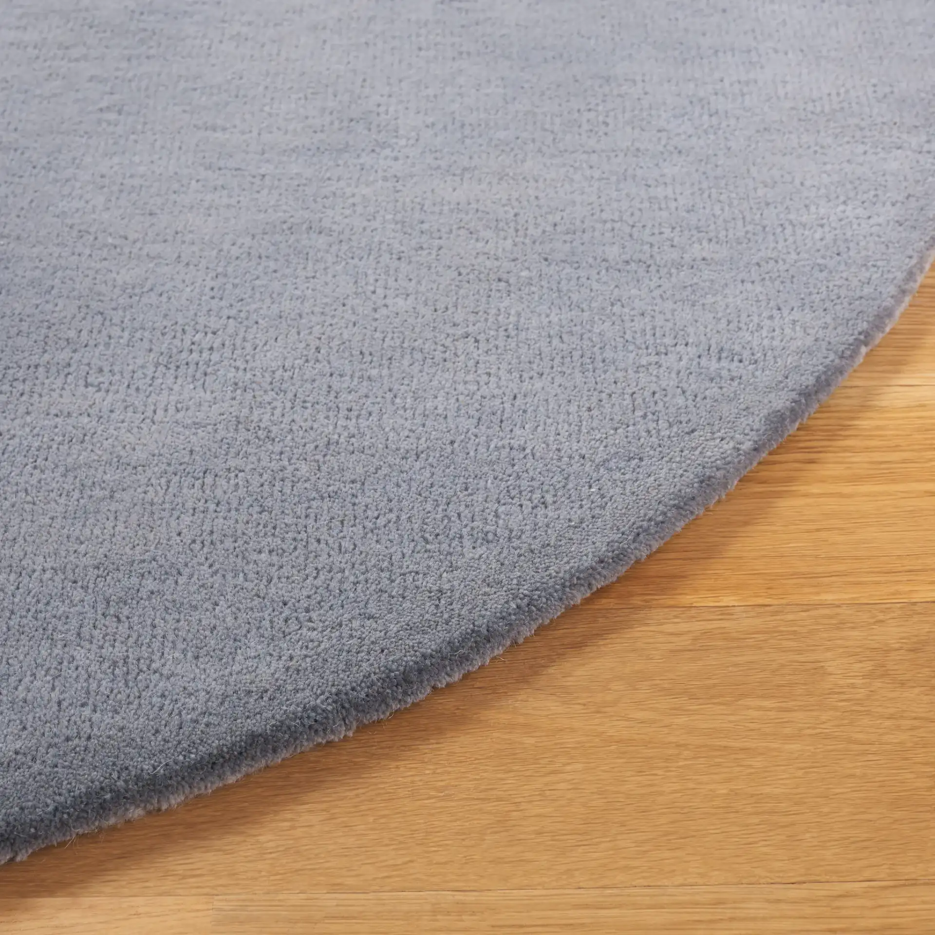 Rodeo Drive Concentric Arch Hand-Tufted Wool Rug in Blue / Ivory in a styled room
