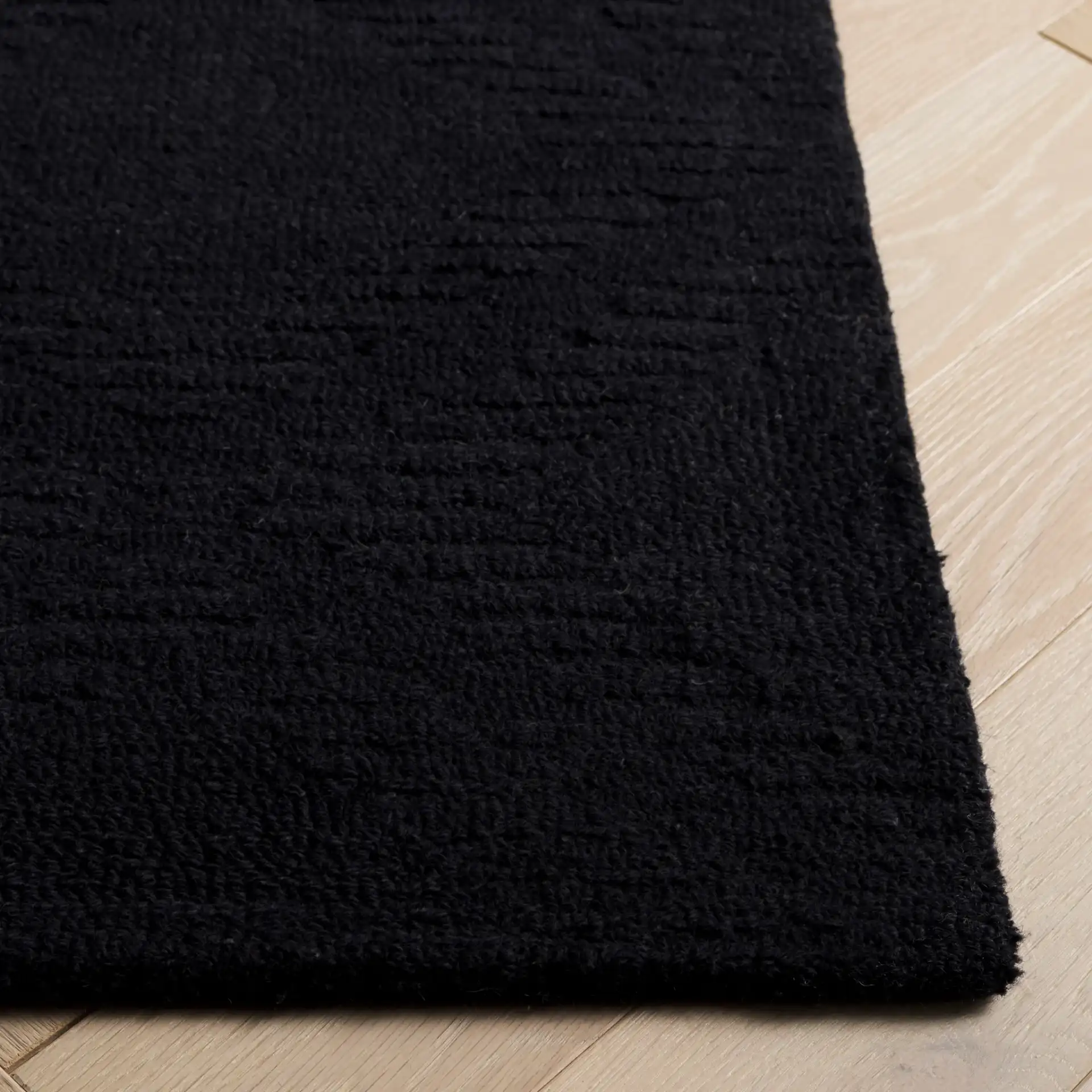 Rodeo Drive Carved Diamond Hand-Tufted Wool Rug in Black in a styled room