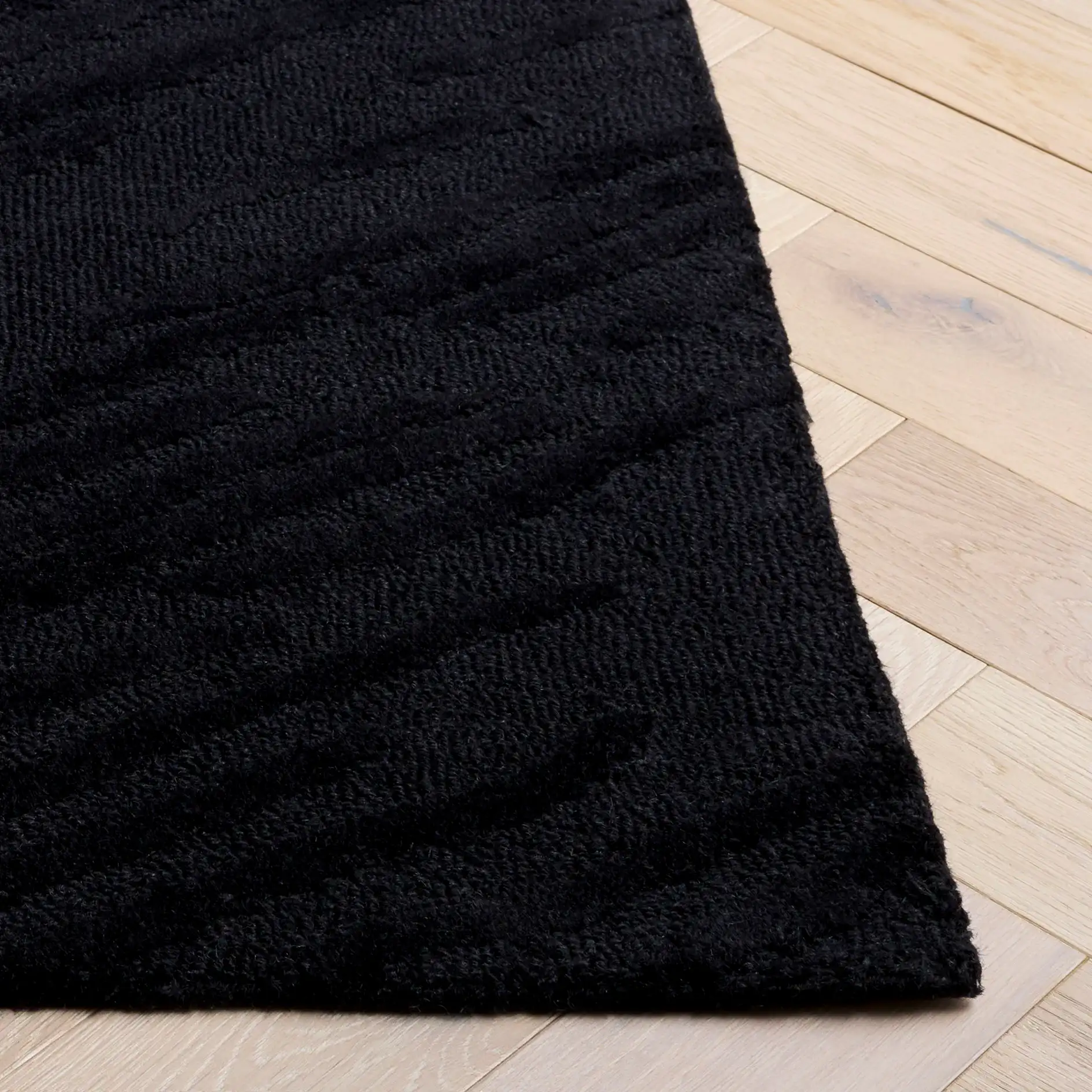 Rodeo Drive Diagonal Stripe Hand-Tufted Wool Rug in Black in a styled room