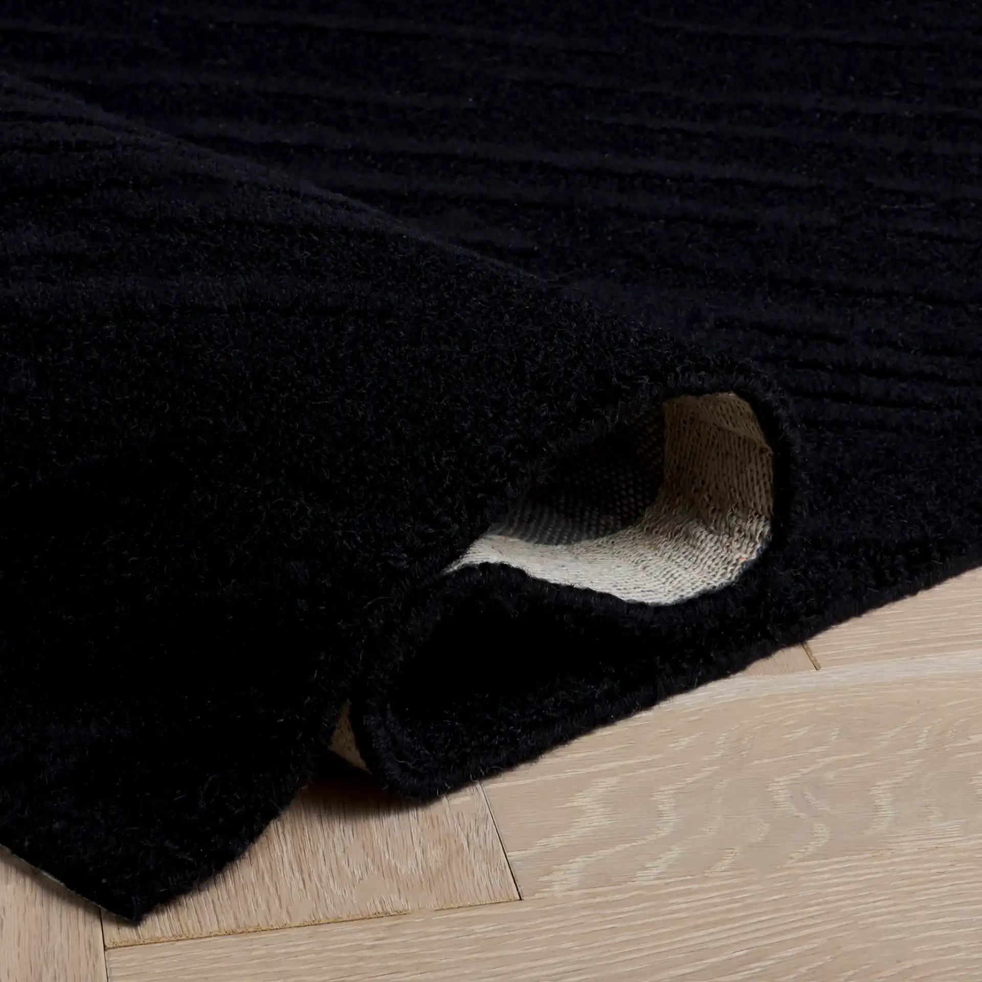 Rodeo Drive Diagonal Stripe Hand-Tufted Wool Rug in Black in a styled room