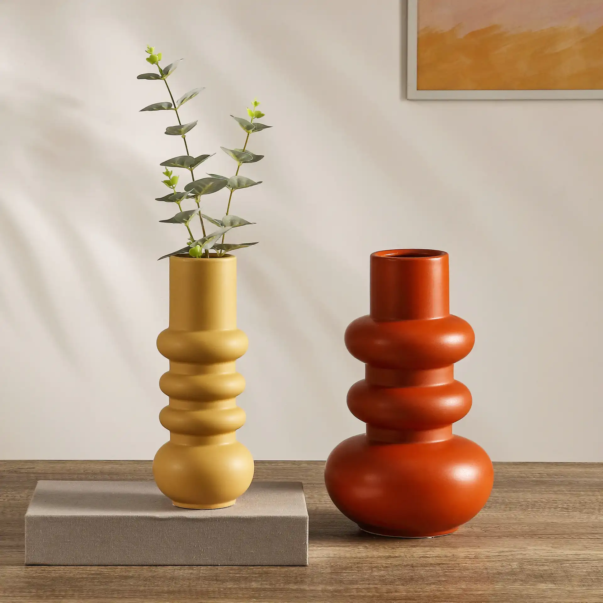 Theissa Ceramic Vase (Set Of 2) in Orange / Pale Yellow in a styled room