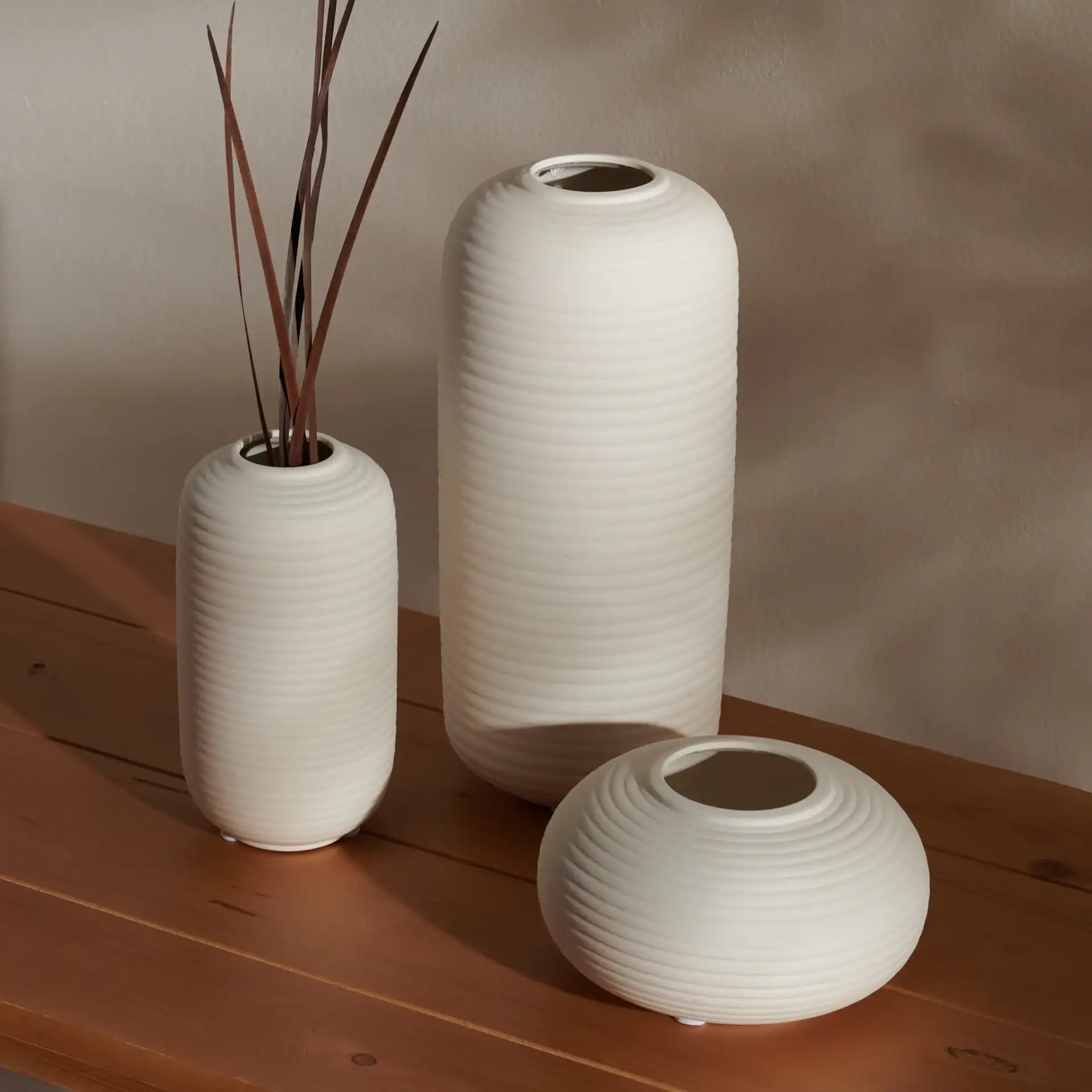 Sora Ceramic Vase (Set Of 3) in Ivory in a styled room