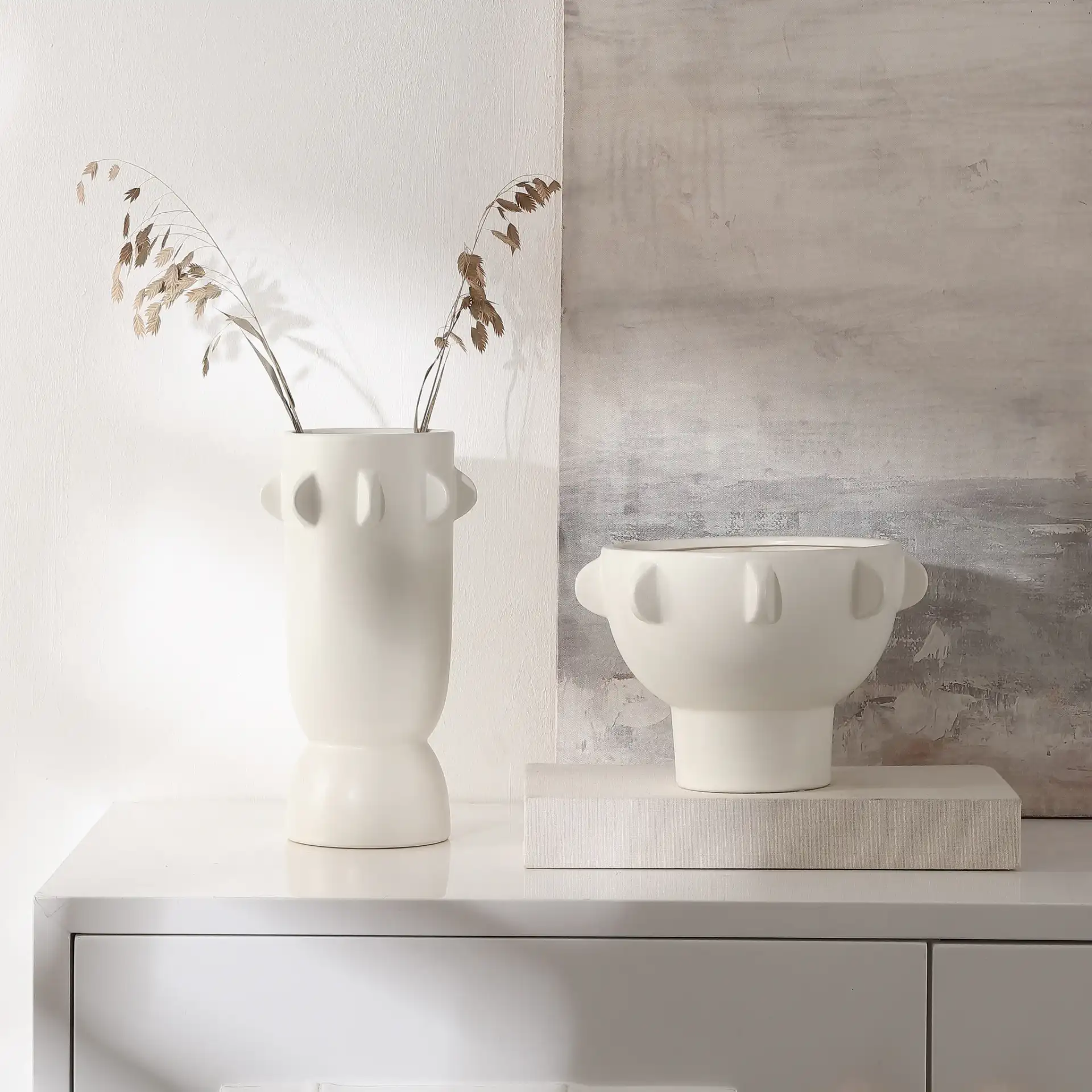 Amias Ceramic Tab Vase (Set Of 2) in Off White in a styled room