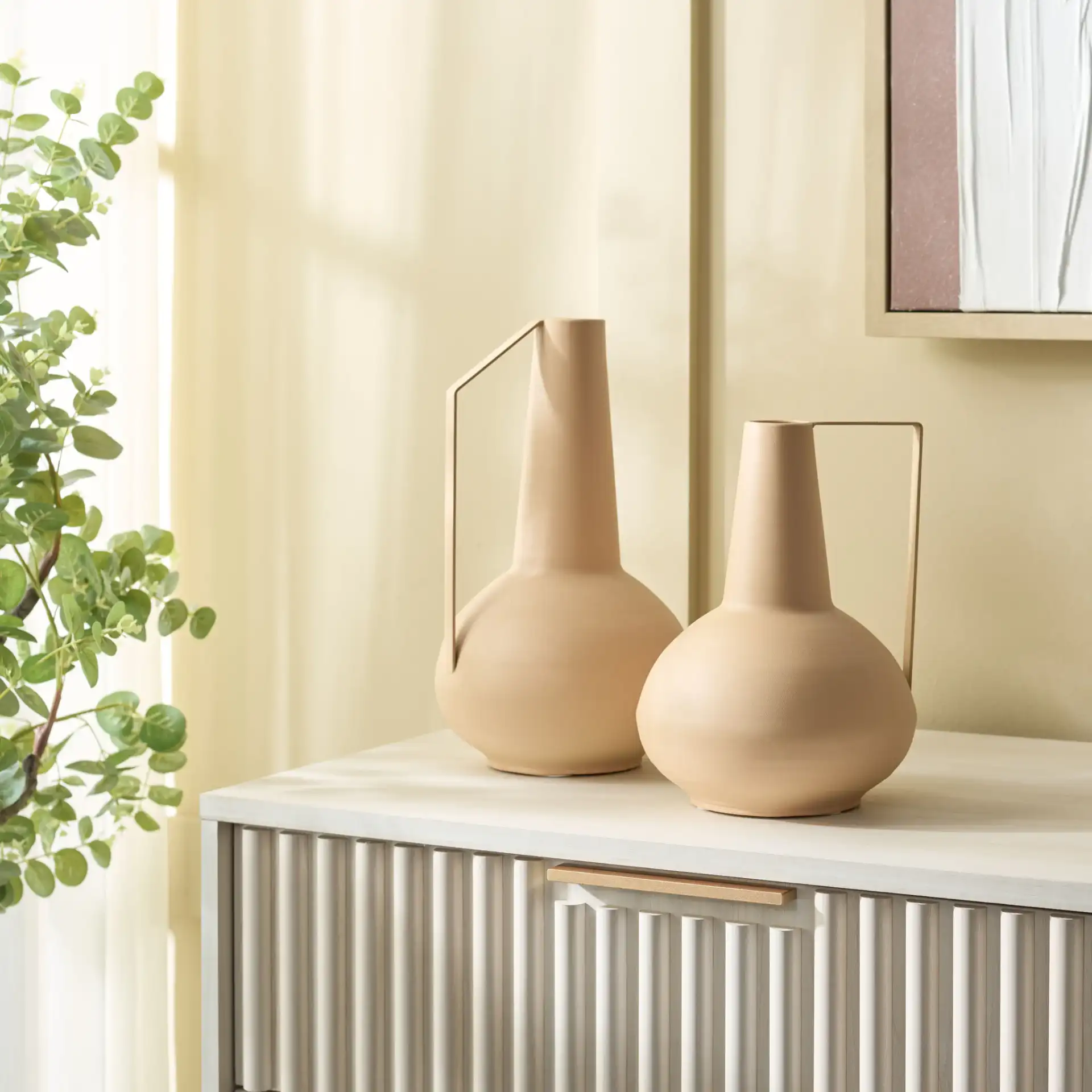 Rafe Iron Vase (Set Of 2) in Beige in a styled room