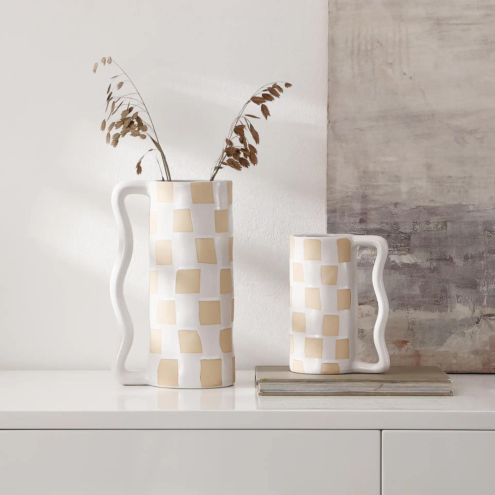 Anika Checkered Handle Vase (Set Of 2) in White / Beige in a styled room