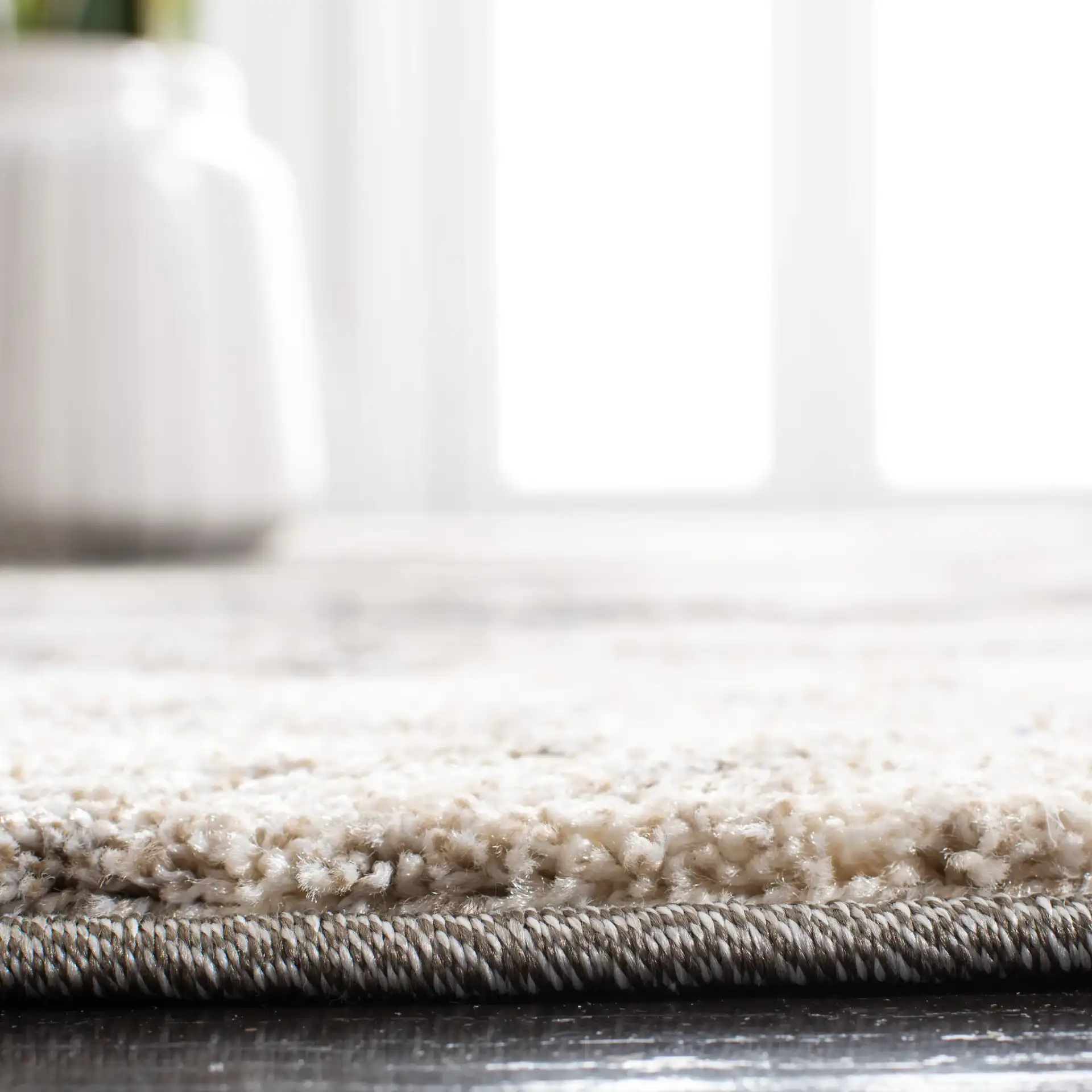 Retro Modern Splatter Abstract Rug in Cream / Gray in a styled room