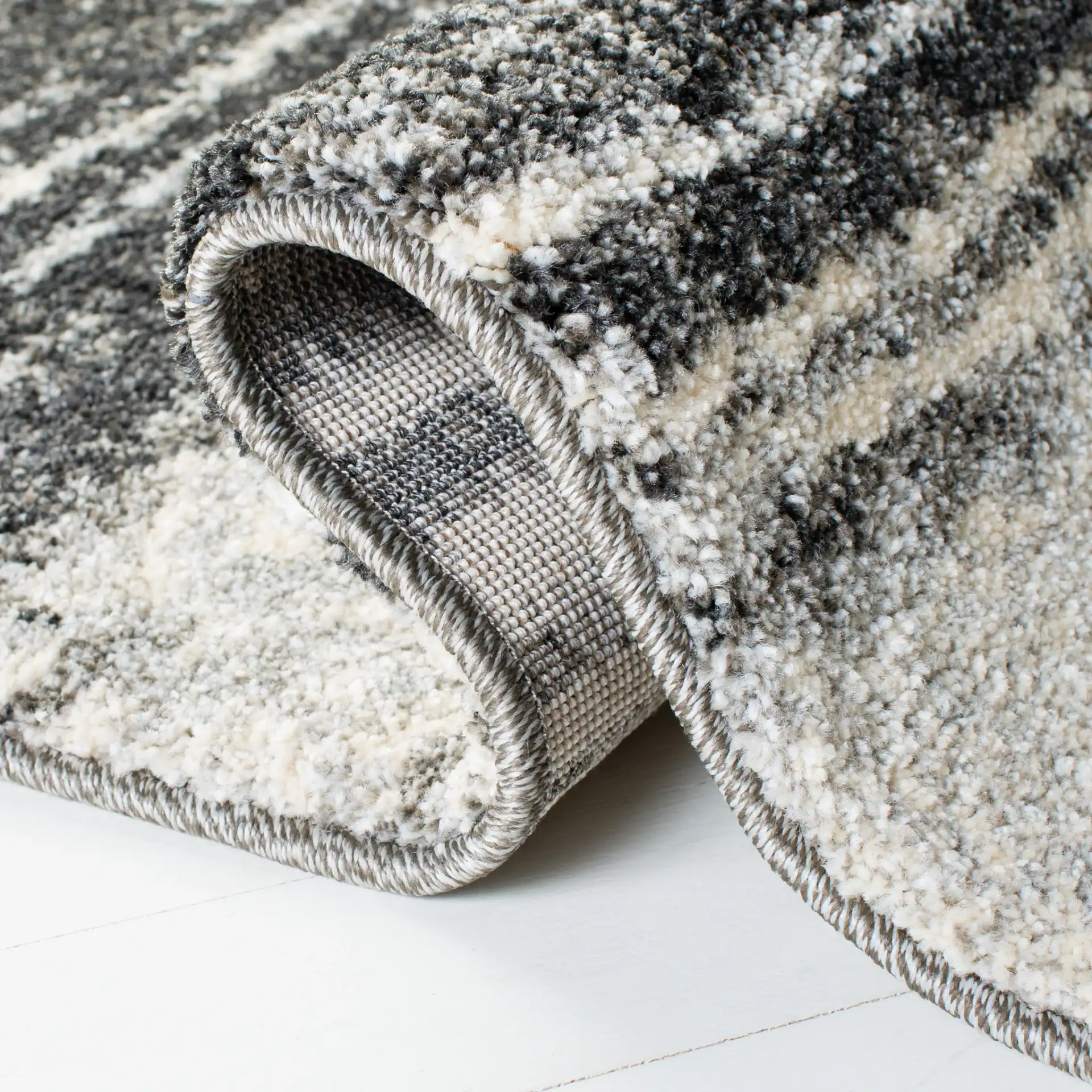 Retro Modern Striped Rug in Dark Gray / Light Gray in a styled room
