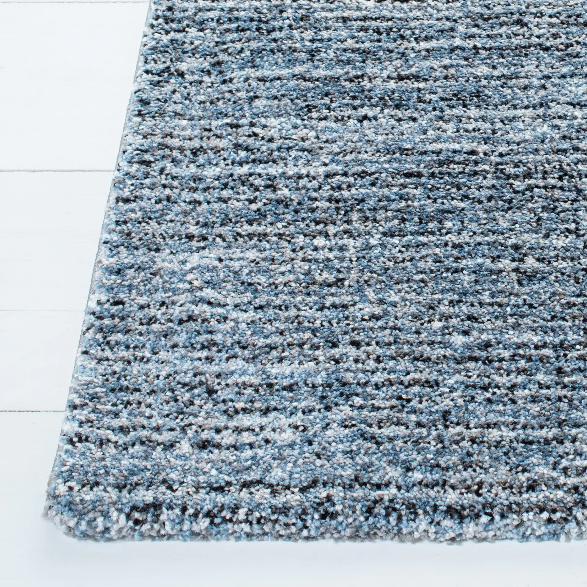 Retro Striated Solid Rug in Gray / Blue in a styled room