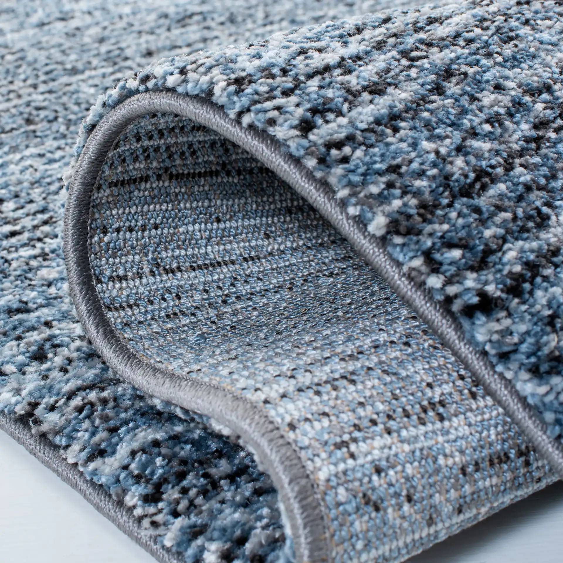 Retro Striated Solid Rug in Gray / Blue in a styled room