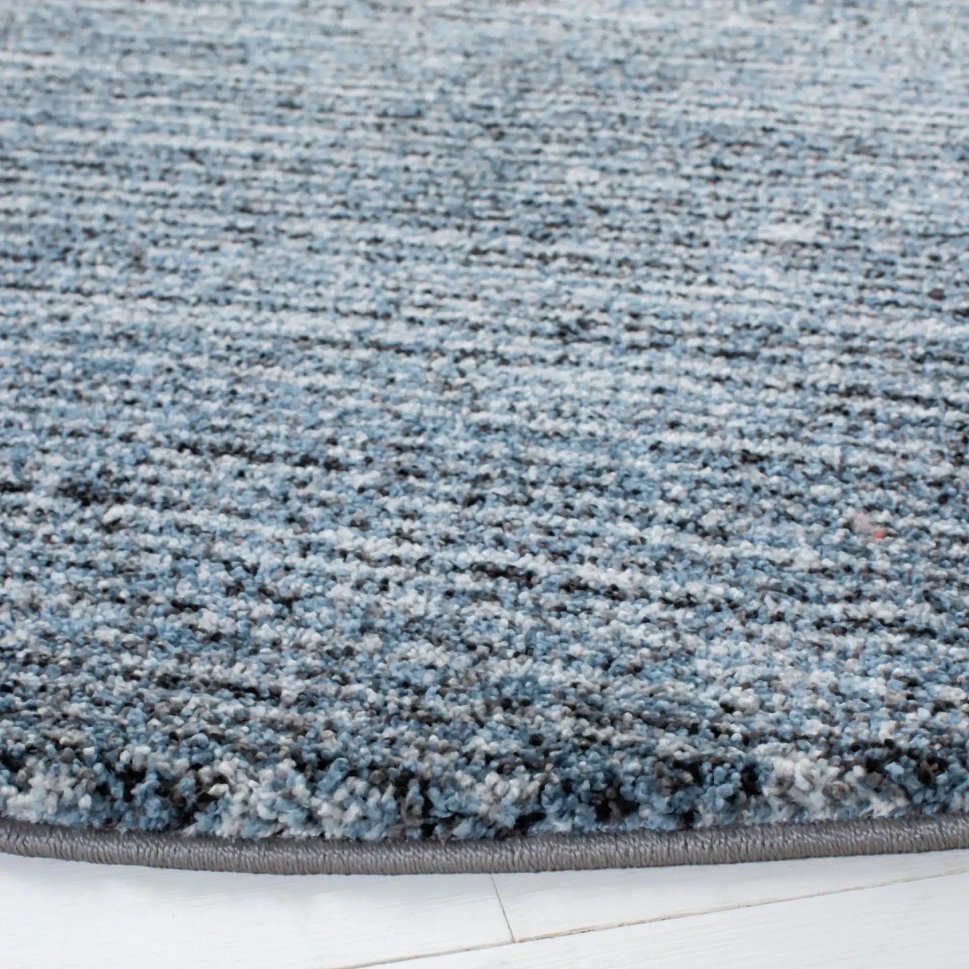 Retro Striated Solid Rug in Gray / Blue in a styled room
