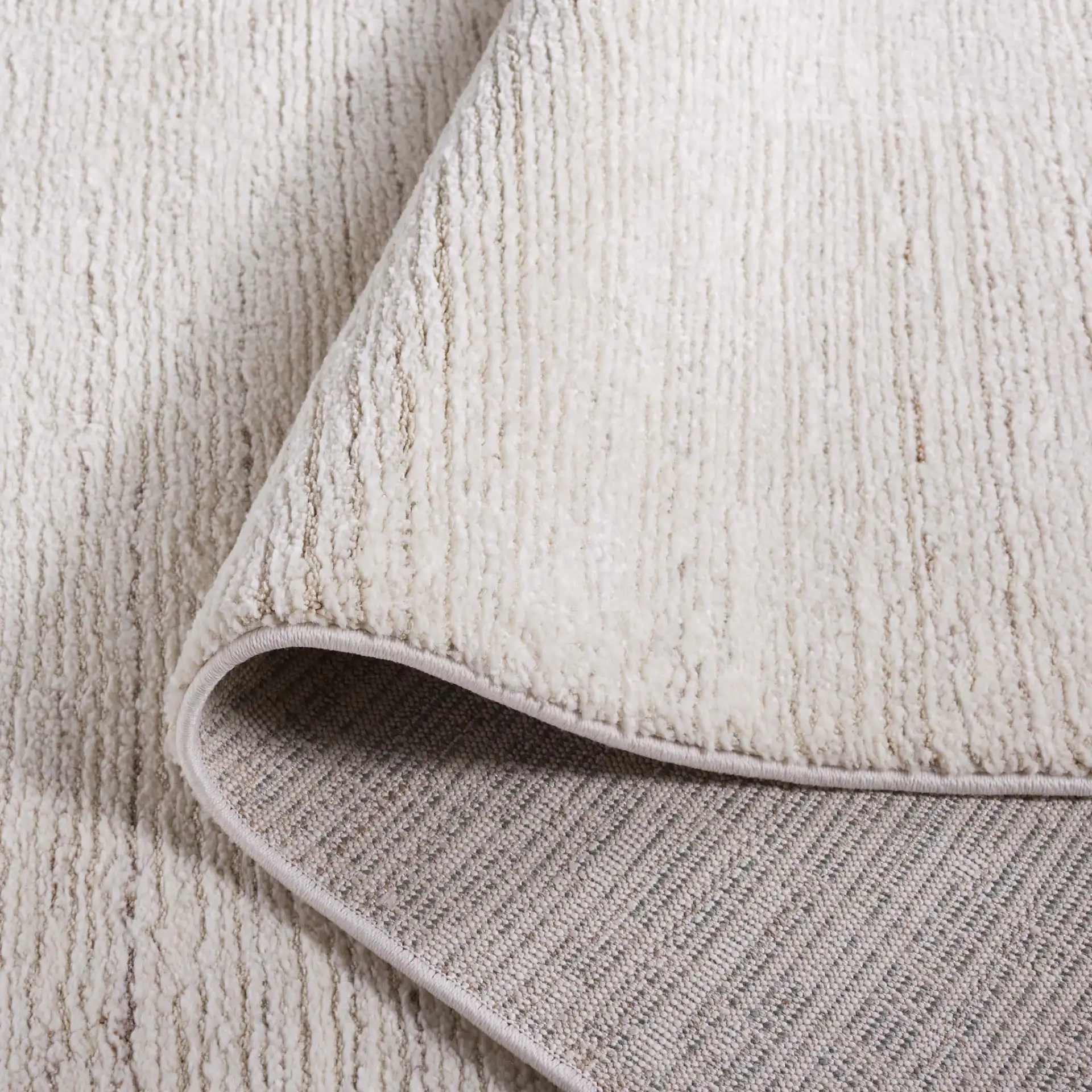 Revive Ribbed Solid Rug in Ivory in a styled room
