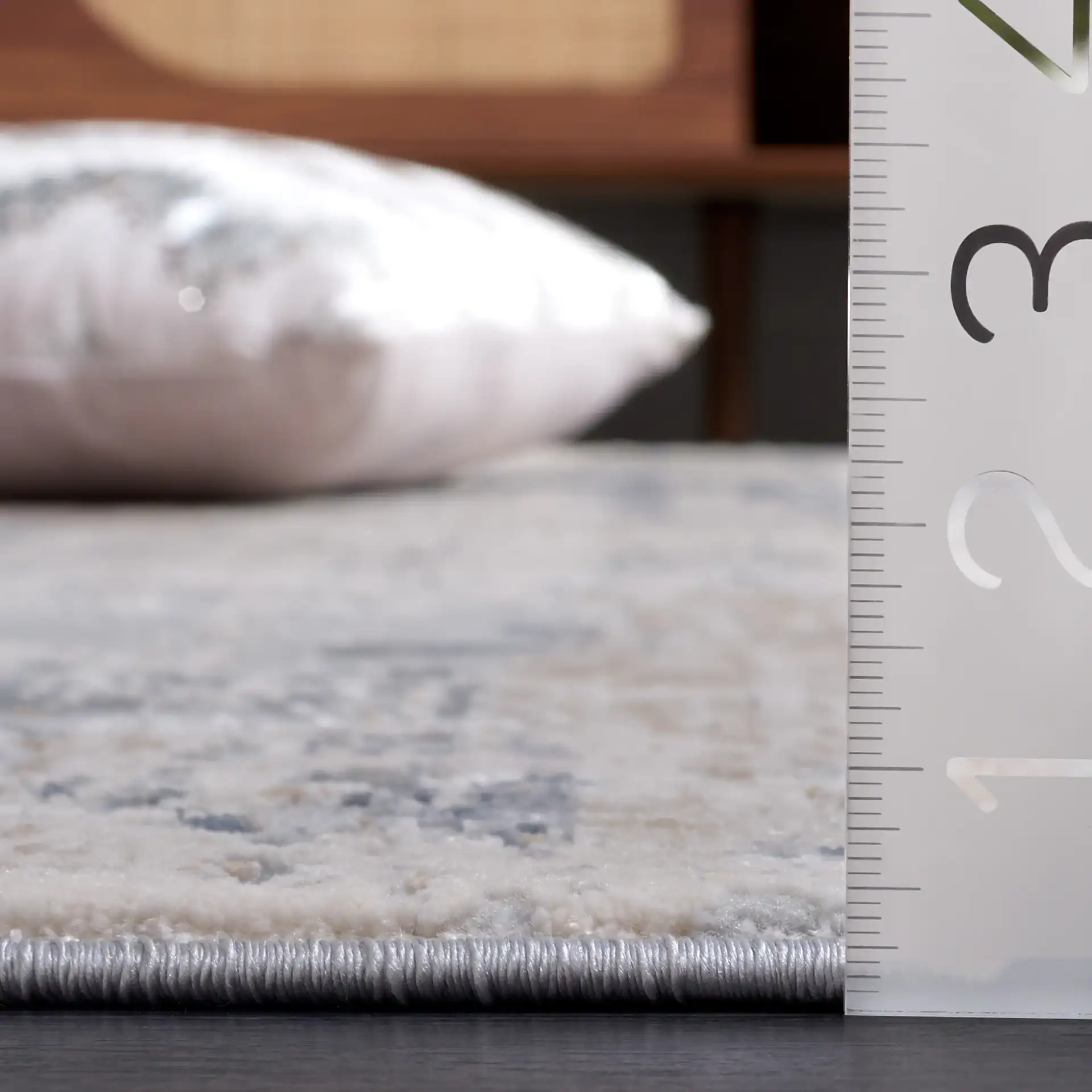 Reflection Distressed Abstract Rug in Cream / Gray in a styled room