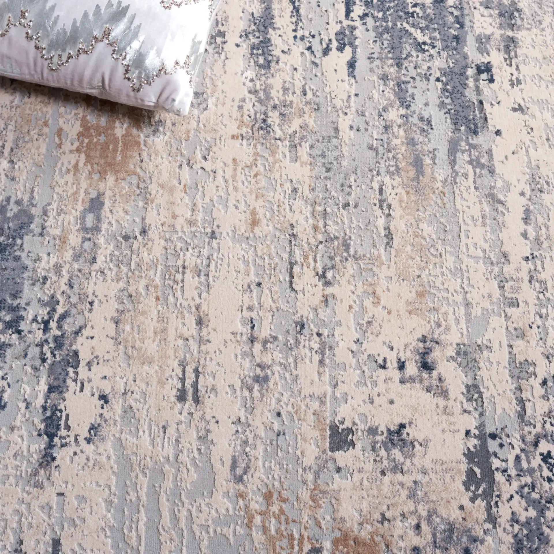 Reflection Distressed Abstract Rug in Cream / Gray in a styled room