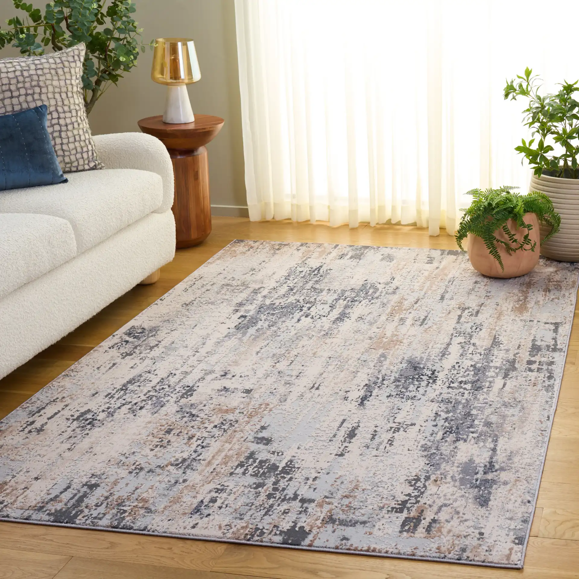 Reflection Distressed Abstract Rug in Cream / Gray in a styled room