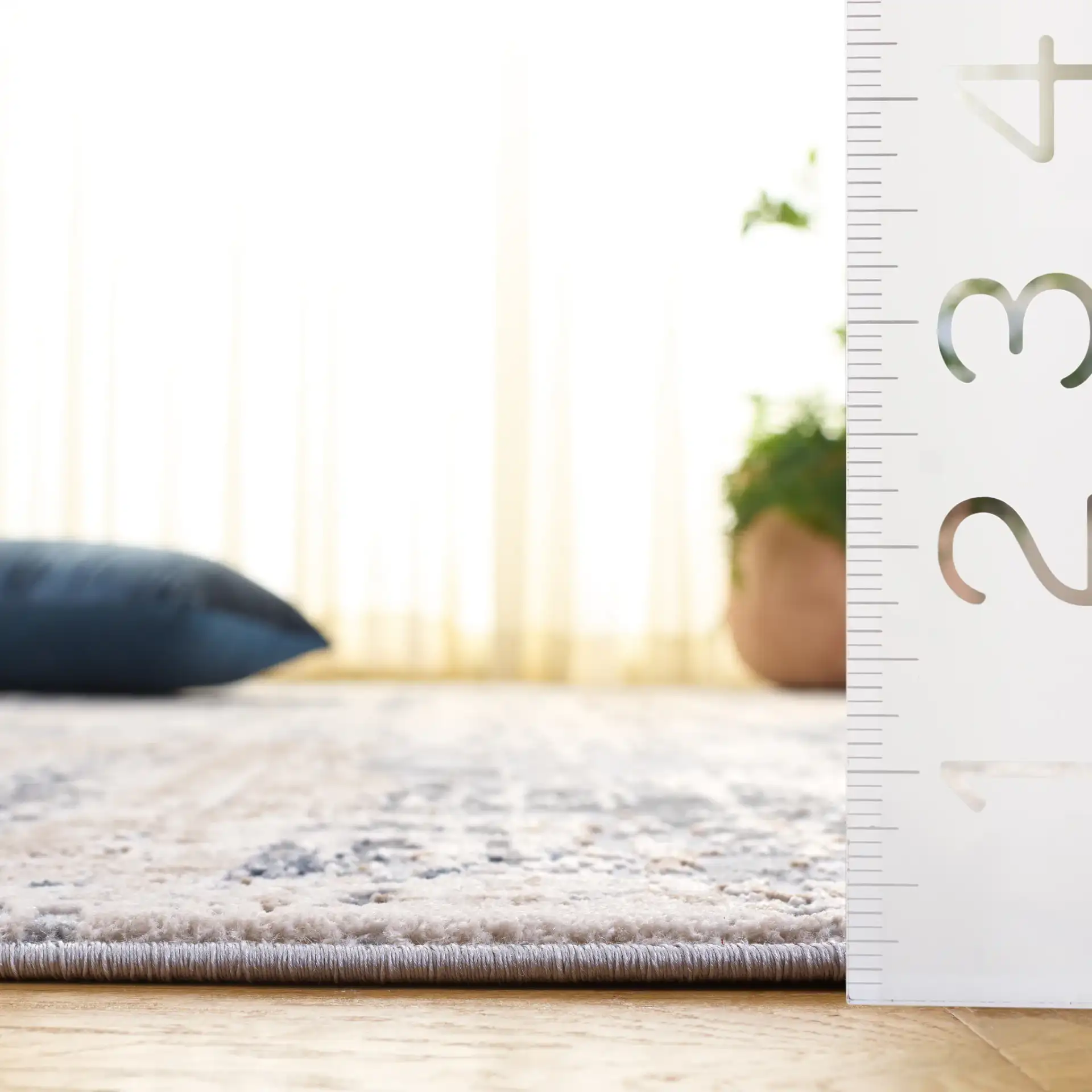 Reflection Distressed Abstract Rug in Cream / Gray in a styled room