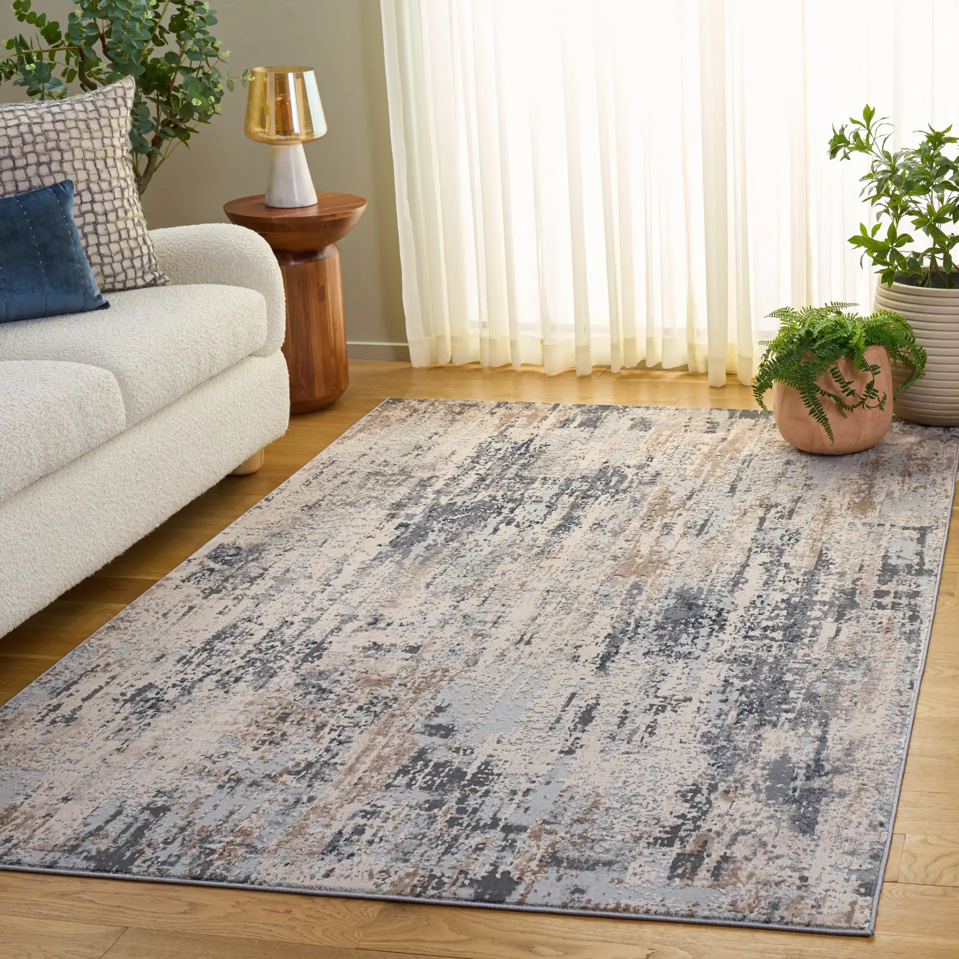 Reflection Distressed Abstract Rug in Cream / Gray in a styled room