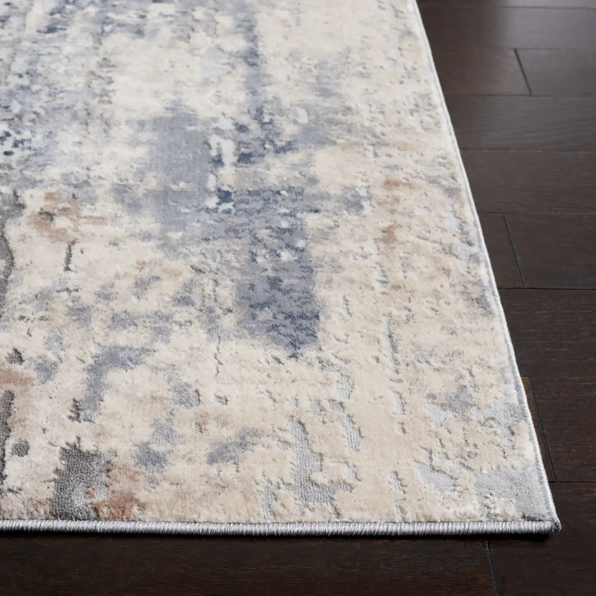 Reflection Distressed Abstract Rug in Cream / Gray in a styled room