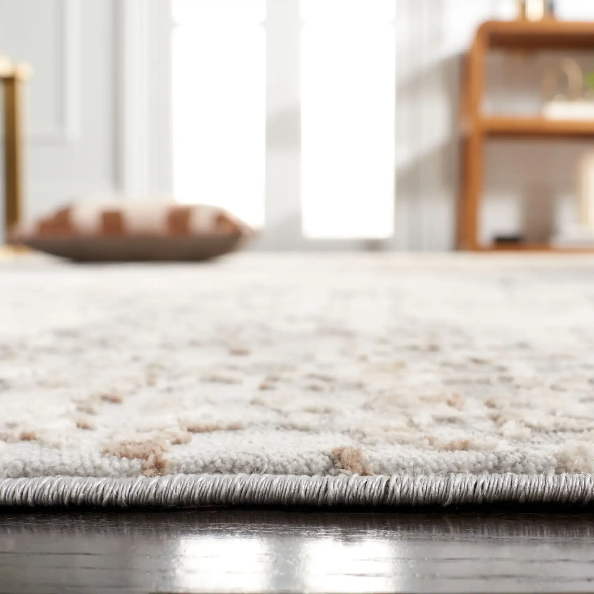 Reflection Distressed Abstract Rug in Cream / Gray in a styled room