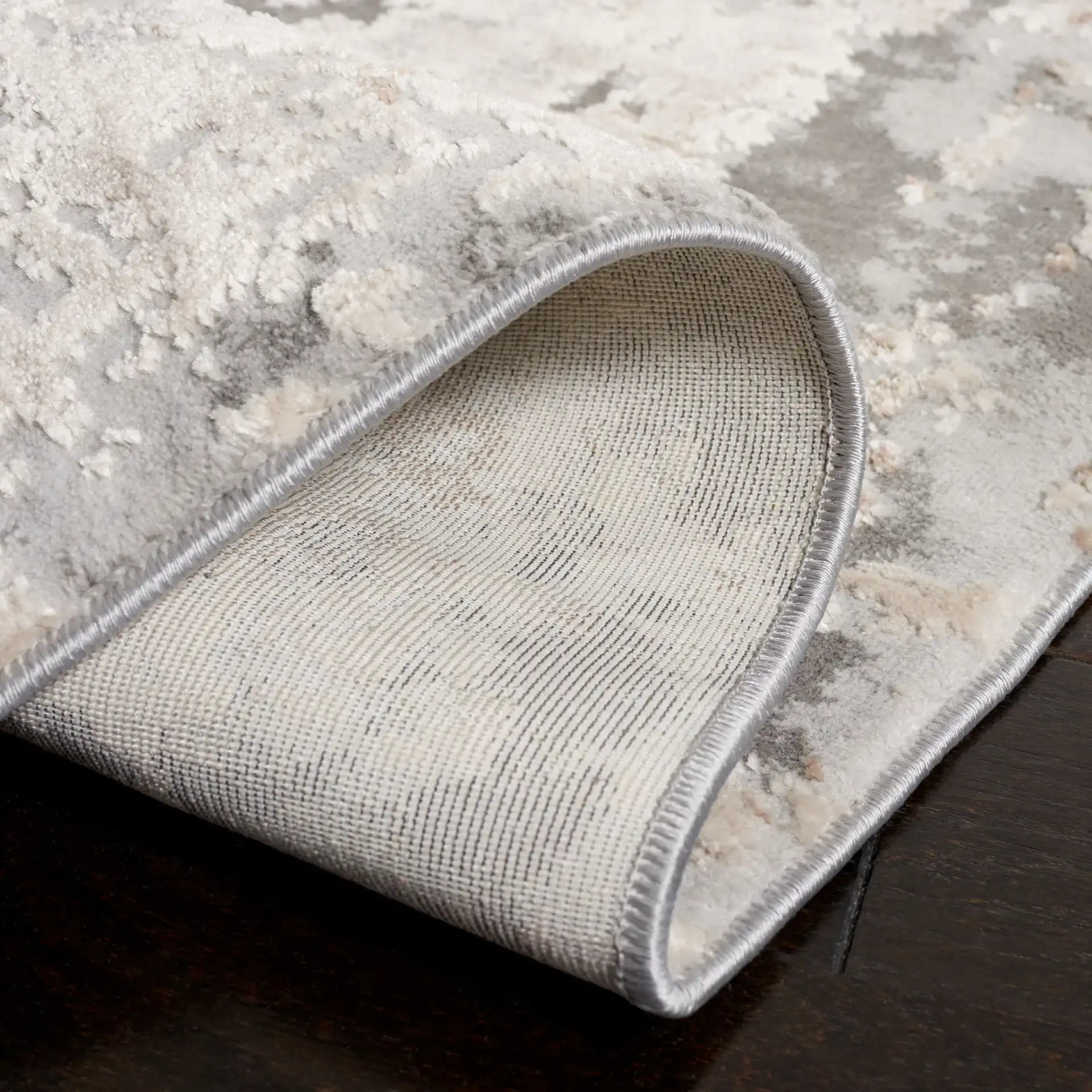 Reflection Distressed Abstract Rug in Cream / Gray in a styled room